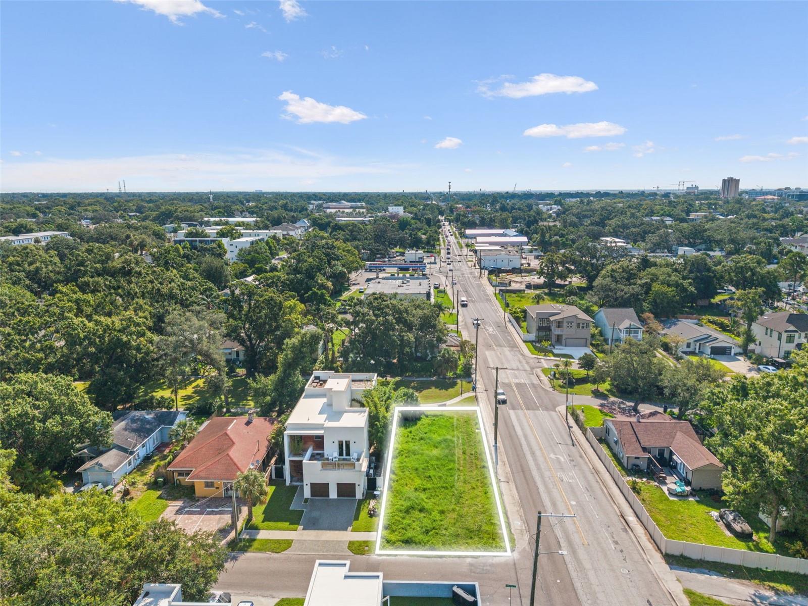 2701 N Myrtle Avenue presents a rare opportunity in the heart of Riverside Heights. This vacant corner lot measures 50 feet wide by 113 feet deep and comes with fully approved 2019 building plans for a 2,600 sq. ft. modern single-family home featuring 3 bedrooms, 3.5 bathrooms, and a rooftop deck. With proper due diligence, you may be able to re-use these plans and streamline the path to construction. The site allows for up to three stories, and with a rooftop deck perched above the third floor, there is the potential to capture stunning views of the Downtown Tampa skyline.
The lot offers a unique backyard advantage with no rear neighbors—backing directly onto the lush greenspace of Phillips Park, an uncommon amenity in this neighborhood. Just a few blocks from Armature Works and Downtown Tampa, the location balances privacy with proximity to Tampa’s best dining, entertainment, and waterfront access.
Surrounding properties underscore the value of the site: next door, a beautiful modern two-story home is valued around $1.5M, while across the street sits a striking modern residence on a double lot valued near $2M. This is a rare chance to build in one of Tampa’s fastest-growing and most desirable urban neighborhoods, combining design potential with lasting value.
Sellers are open to construction-to-permanent financing buyers and can accommodate extended closing timelines.