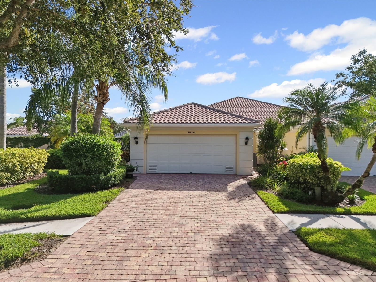 Stunningly updated pool home in the best location in VillageWalk. This villa feels like a detached home, with a serene park-like setting in front and ample side and back yards bordered by privacy walls. The perfect setting for enjoying the saltwater heated pool (resurfaced this year) and extended screened lanai. Bathed in natural light, this move-in ready home boasts a spectacular remodel featuring contemporary materials and finishes. Luxury vinyl flooring throughout, a reconfigured kitchen with crisp white shaker-style cabinetry, gorgeous quartz and granite countertops, and a striking shiplap wall are just a few of the features that makes this home stand out from the rest. This popular Capri model also comes with clear hurricane shutters and an epoxy-coated garage floor. VillageWalk offers an array of amenities, including a resort-style pool, lap pool, clubhouse, fitness center, library, hair salon, café with bar, and gas station. Outdoor enthusiasts will appreciate the tennis, pickleball, basketball, bocce ball courts, and miles of walking paths in this luxurious lifestyle community. Come see for yourself why this truly fabulous villa is second to none.