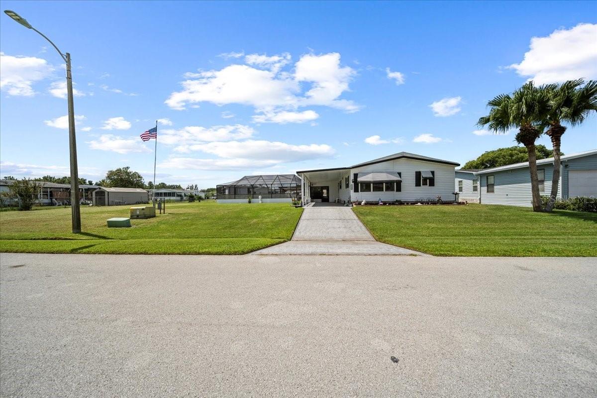 If you're looking for outdoor living with no HOA, space to park your boat, a private in-ground pool with screen enclosure, and a canal behind the home where you can kayak or fish—this is your new home! Welcome to Mount Olive Heights in Polk City, where comfort, updates, and space come together on a just-under–½-acre lot where you own the land. This beautifully updated 2-bedroom, 2-bath manufactured home offers just under 1,500 sq. ft. of living space with an open floorplan, a large living room with access to the screened front porch, and a separate dining room. The kitchen features stainless steel appliances, wood cabinets, tile flooring, a tile backsplash, pantry, and a center island perfect for entertaining. The primary bedroom includes carpet, while the hallway and both bathrooms have tile flooring. The bathrooms feature updated faucets, updated cabinets, ceramic sinks (2025), and all interior doors have been upgraded. Additional improvements include new roof (2025), updated plumbing, a water purifier for drinking water, new double-pane windows (2023), luxury vinyl plank flooring (2025), a water heater (2019), and AC system (2020). Outdoor living shines with two open patios and a peaceful canal view in the backyard. The home also offers crown molding, knockdown textured ceilings, Levolor blinds throughout, a single-car carport, extended driveway, and a 10x10 storage shed. Conveniently located off SR 33 near Lakeland, Haines City, and Winter Haven, with easy access to I-4, Tampa, Orlando, and Central Florida attractions.
