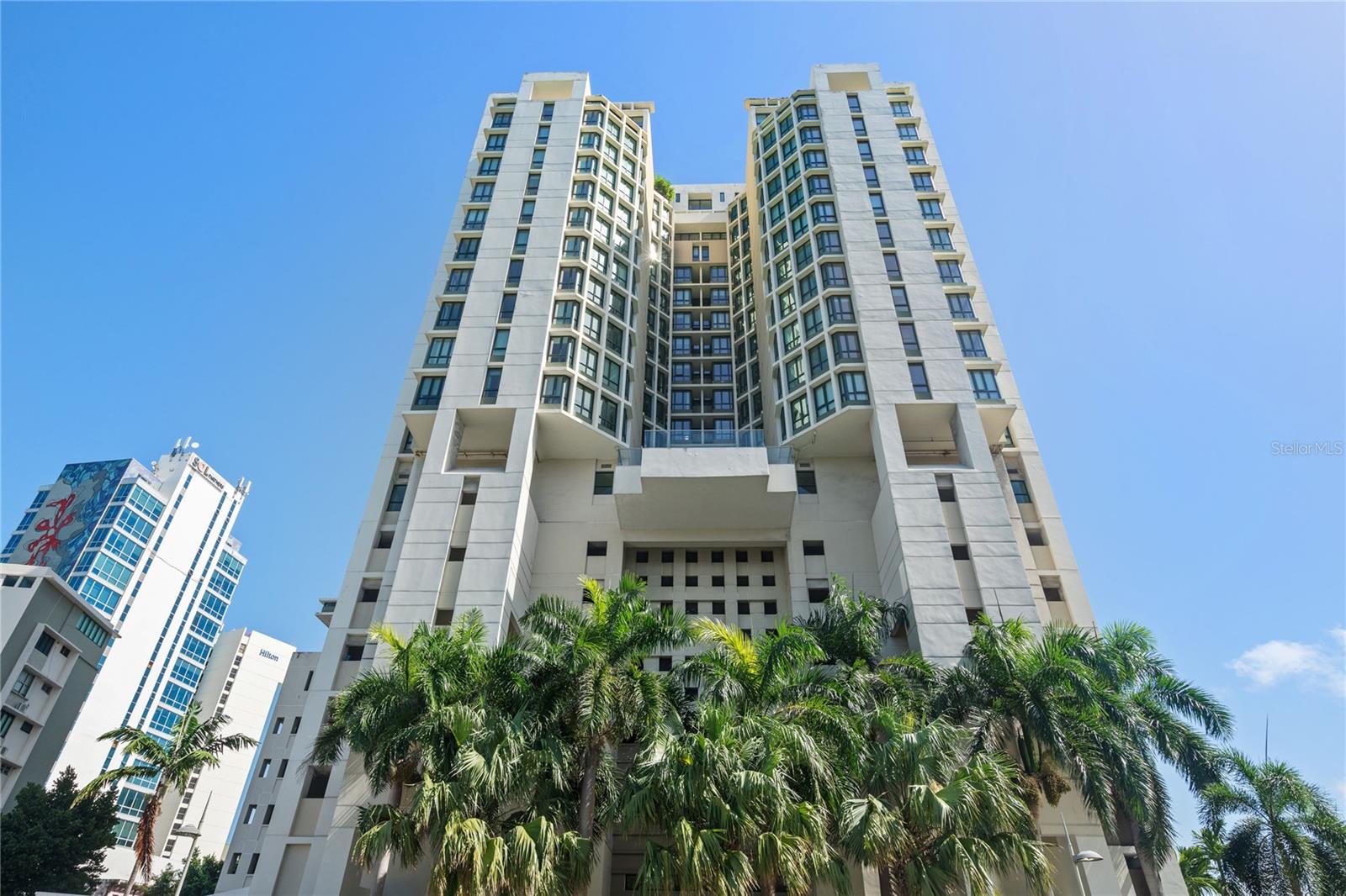 One or more photo(s) has been virtually staged. Experience the pinnacle of luxury living in this rarely available 16th floor residence in the coveted Caribe Plaza within the Paseo Caribe complex. With ocean views during the day and city views at night, you can have it all. Private, keyed elevator access opens directly into your personal lobby. Enjoy unobstructed water views from every room in this refined, 16th floor oasis. Embrace the unique opportunity to tailor this apartment to your personal taste and style. This inviting space offers a wonderful canvas for your design ideas, turning your vision of a dream home into reality. Three large, ensuite bedrooms with oversized custom closets and a smaller 4th bedroom or office with a full bathroom. Oversized, eat-in kitchen with double islands, oversized refrigerator/freezer and electric cooktop. This trophy property also includes 3 deeded, underground parking spots and a private storage room.
Caribe Plaza is the premier, full-service, luxury building in San Juan. Located between the beach, a 27 acre waterfront park and Condado’s renowned nightlife without the dreaded Condado traffic. The building is completing a multi-year, $5M renovation; including new hurricane proof, soundproof, and energy efficient windows throughout as well as many other upgrades. With amenities like free valet parking, doorman, concierge, 24/7 security, 8th floor pool overlooking the ocean, sauna, full backup generator, water cistern, residents lounge and more, this building has it all…even the gym has water views! Its central location at Paseo Caribe ensures convenient access to Old San Juan, downtown Condado, Miramar, Guaynabo, and the San Juan International Airport.