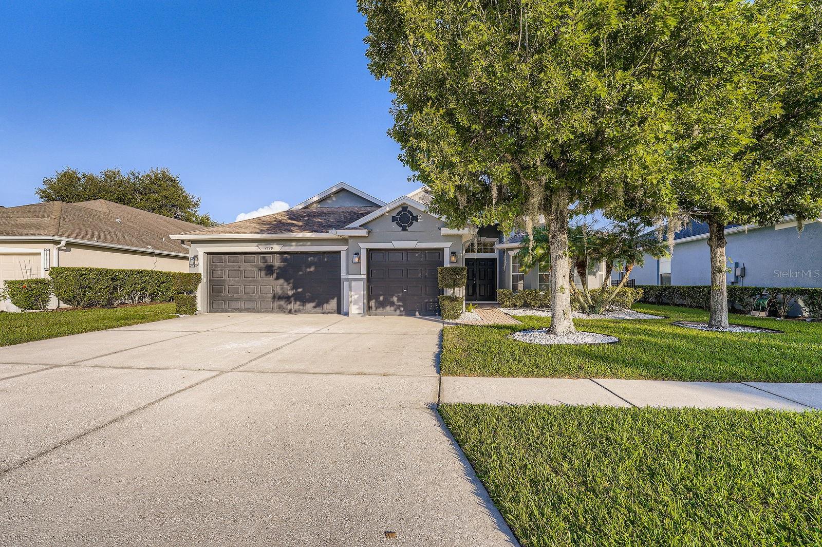 Welcome to this grand and light-filled 5-bedroom, 3-bathroom home offering a perfect blend of comfort, elegance, and functionality. Situated in a desirable community with top-tier amenities, this residence is designed for both everyday living and effortless entertaining. Step inside to an open-concept layout featuring soaring ceilings, an abundance of natural light, and stylish ceramic tile and laminate wood flooring throughout. The heart of the home is the spacious kitchen, complete with rich dark-stained cabinetry, granite countertops, and a full suite of stainless steel appliances. Enjoy seamless flow from the kitchen to the breakfast room—with custom wrap-around built-in bench seating—and into the inviting living room, where a cozy fireplace and built-in bookshelves add charm and warmth. Large windows frame picturesque views of the enclosed paver patio and luxurious screened-in private pool, creating a true indoor-outdoor living experience. One of the home’s three bathrooms offers convenient direct access to the pool—perfect for entertaining guests. The expansive primary suite is a tranquil retreat, featuring high ceilings and abundant natural light. The ensuite bathroom is generously sized with dual vanities, a separate soaking tub, a walk-in shower, and a spacious walk-in closet. Four additional bedrooms on the main level provide ample space for family or guests, with a versatile bonus room upstairs ideal for a home office, gym, or media room. This home is located in a vibrant HOA community offering resort-style amenities including a clubhouse, two community pools, a pond, tennis courts, playground, and basketball court. Don’t miss the opportunity to own this beautifully appointed home in a sought-after neighborhood.