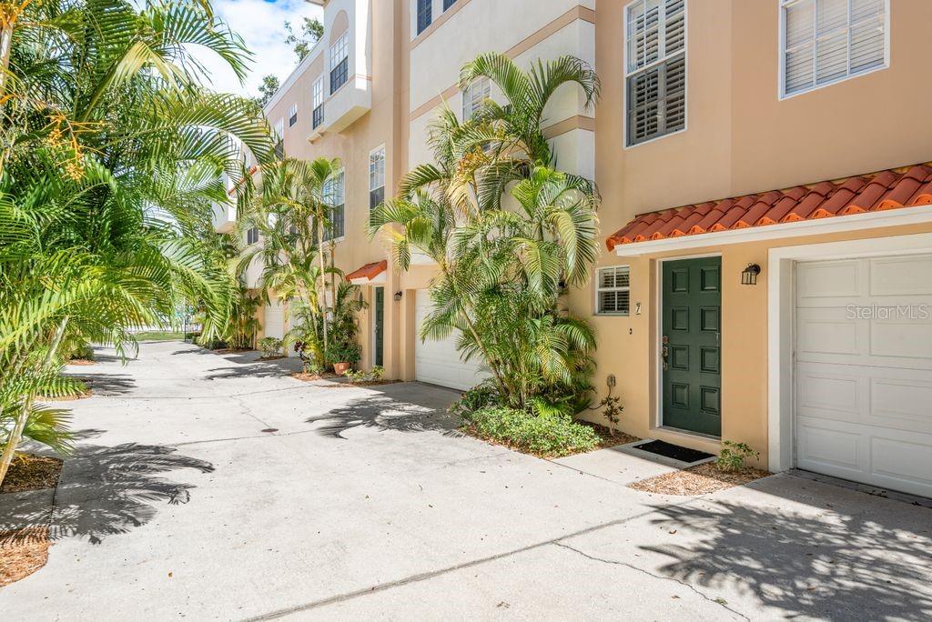 Mediterranean-Style Townhome in the Heart of South Tampa – 509 Matanzas Ave, Unit 7. Tucked just west of Hyde Park in the highly sought-after South Tampa neighborhood, 509 Matanzas Avenue, Unit 7, offers the perfect blend of charm, modernupdates, and unbeatable location. This quiet Mediterranean-style community of only 8 townhomes was built in 2005 and is surrounded by lush tropical landscaping. As you arrive at Unit 7, you'll appreciate the privacy of your two-car garage and well-manicured entry. Step inside to the ground level foyer where you'll find a spacious laundry room with backyard access. Upstairs, the main living area impresses with rich wood flooring, crown molding, plantation shutters, and an open-concept layout perfect for entertaining. The updated kitchen is the heart of the home, featuring 2025 freshly painted cabinetry with upgraded hardware, newer pantry door, a 2024 refrigerator, 2021 quartz island countertop with newer stainless steel sink and lighting, Bosch dishwasher, and stainless steel Samsung appliances.The formal dining room comfortably seats six under a statement chandelier, and the adjoining living room showcases a custom stone feature wall ideal for your mounted TV. A convenient half-bath is also located on this level. Upstairs, the sunlit primary suite offers a walk-in closet and a luxurious bathroom with dual vanities, granite countertops, a frameless glass shower, and a private water closet. Down the hall, the guest bedroom has a walk-in closet and maintains the elegant crown molding. It is adjacent to a full guest bathroom with granite countertops, updated 2020 tile flooring, and a shower/tub combo plus a beautiful upgraded door. Recent updates include: 2023 backyard turf installation, 2019 roof, 2016 HVAC system. Various kitchen and bath upgrades between 2020–2025, and 2025 interior paint, 2025 dryer vent on exterior of building replaced. With low HOA fees of just $200/month and no known assessments. This is an exceptional opportunity for stylish, low-maintenance living. Location highlights: Minutes from Hyde Park, Bayshore Blvd, Downtown Tampa, I-275, and Tampa International Airport, plus close proximity to premier restaurants like On Swann, Olivia, and Meat Market, and top grocery stores including Whole Foods, Publix, and Fresh Market.the