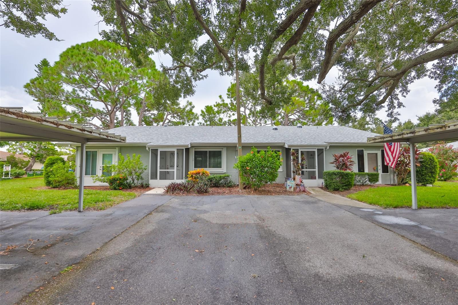Perfect retirement home located in the gated community of Kings Point where exterior maintenance is included in the condo fees leaving you free to enjoy the numerous amenities available in a resort lifestyle retirement in sunny Florida. This home is scheduled for a new roof August 2025. It features 2 bedrooms, 2 baths and is located in a private cul-de-sac with covered parking for 2 vehicles right outside your front door. It features an enclosed lanai with hurricane proof windows and an oversized laundry/storage room. For added peace of mind it also has exterior mounted hurricane sliders on the other windows. Check it out now - don't miss owning your own little piece of paradise!! Here you will find 2 clubhouses, a theatre, golf, state-of-the-art fitness centers, tennis courts, pickleball court and numerous clubs - everything you'd ever want. Sun City Center is also conveniently located close to beaches, shopping, restaurants, professional sporting events and airports. Banks, shopping, churches, doctors and the hospital are just a short golf cart ride away. Sun City Center is ranked the country's top place to retire!!!
