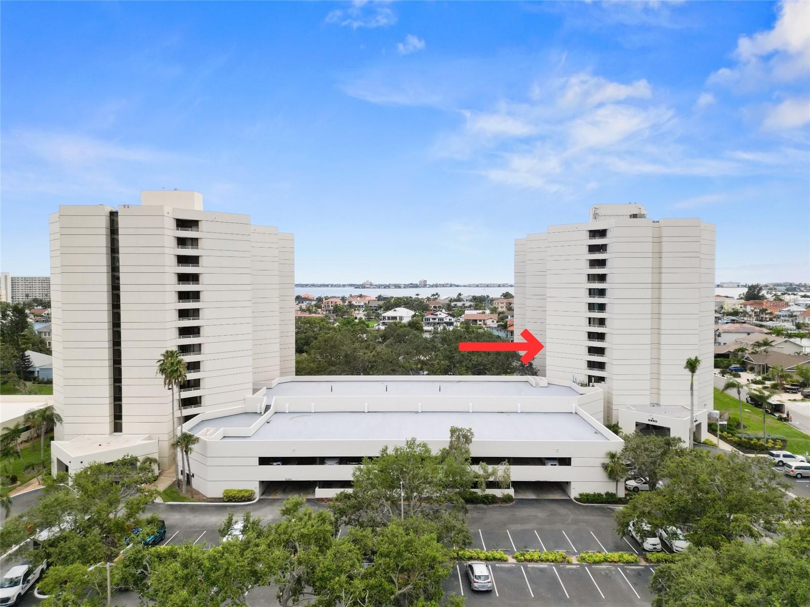 Welcome to 5950 Pelican Bay Plazas #605! Nestled in the highly desired gated community of Pasadena Yacht & Country Club in Bldg A. This unit offers 1,476 sqft of living space and a double balcony with sparkling views of Boca Ciega Bay and mature trees on a small pond. Thoughtfully designed split floor plan with each bedroom including its own ensuite bath, large walk-in closet, and access to the outdoor balconies. Both bedrooms are very spacious and located on opposite sides from each other, giving everyone ample space and privacy. Open living room area. The kitchen features granite counters, stainless steel appliances, wood cabinetry, and a cozy dining area. This unit also features a laundry closet w/ washer and dryer and electric storm shutters for added protection. Bldg A has secured, keyed entry, reserved garage parking (and outdoor parking), impressive 2 story lobby with soaring ceilings, billiards, library, exercise room, community pool / spa, and the Commodore’s Community Room! With an added membership, enjoy everything PYCC has to offer including fine and casual dining, 18 hole golf course, tennis and pickleball, fitness, waterfront heated pool, and protected marina. Location is close to award winning beaches, restaurants, vibrant downtown St. Pete and an easy 30 minute drive to Tampa. Don’t miss your chance to call this home your own!