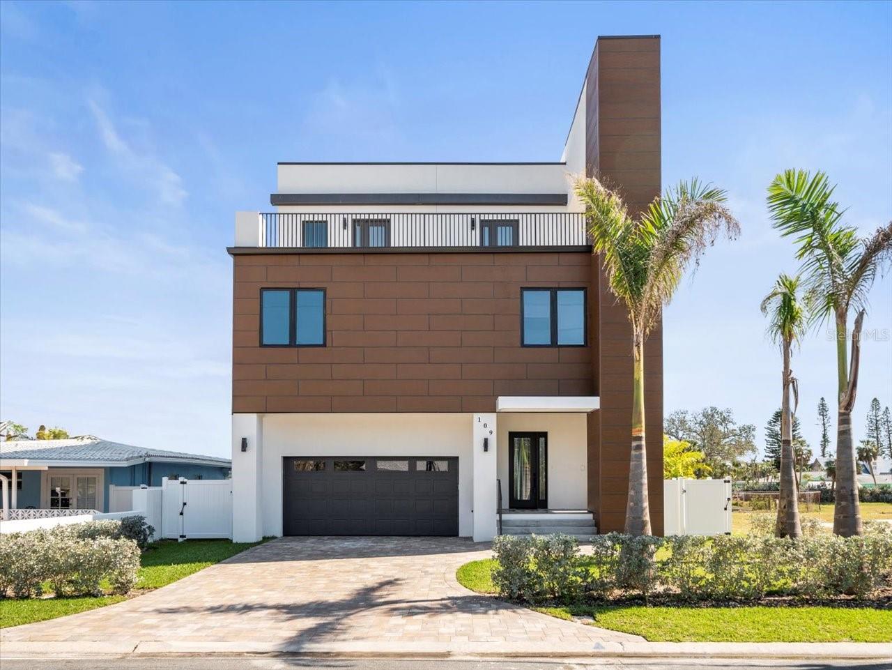 One or more photo(s) has been virtually staged. NEW CONSTRUCTION-WATERFRONT ESTATE - Welcome to your new luxurious estate located on highly desirable St. Pete Beach! Completed construction in late 2023, with new balconies installed in early 2025, this modern home boasts water views from every room. The ground floor consists of a multi car garage with the capacity to add a lift for additional car storage. As you walk towards the terrace, you will find a waterfront pool and full size outdoor kitchen suitable for all your entertaining needs. The second floor has an open floor plan design. Here you will find a large family room, full sized kitchen and breakfast bar. Adjacent to the family room, you will find a large dining room. The family room and dining space have panoramic views of the water. Located off of the open concept family space, is a spacious balcony where you can enjoy beautiful views of Boca Ciega Bay. The second floor includes two bedrooms each with its own en-suite bathrooms. The third floor has a large master suite with a spacious private balcony and a large master bathroom. This floor a bonus space that could either be a third bedroom, home office, or gym. Across the hall there is also a laundry/storage room. This waterfront estate has a centralized elevator that can help you or your guests travel throughout your home with ease. Come make this waterfront paradise your future home!