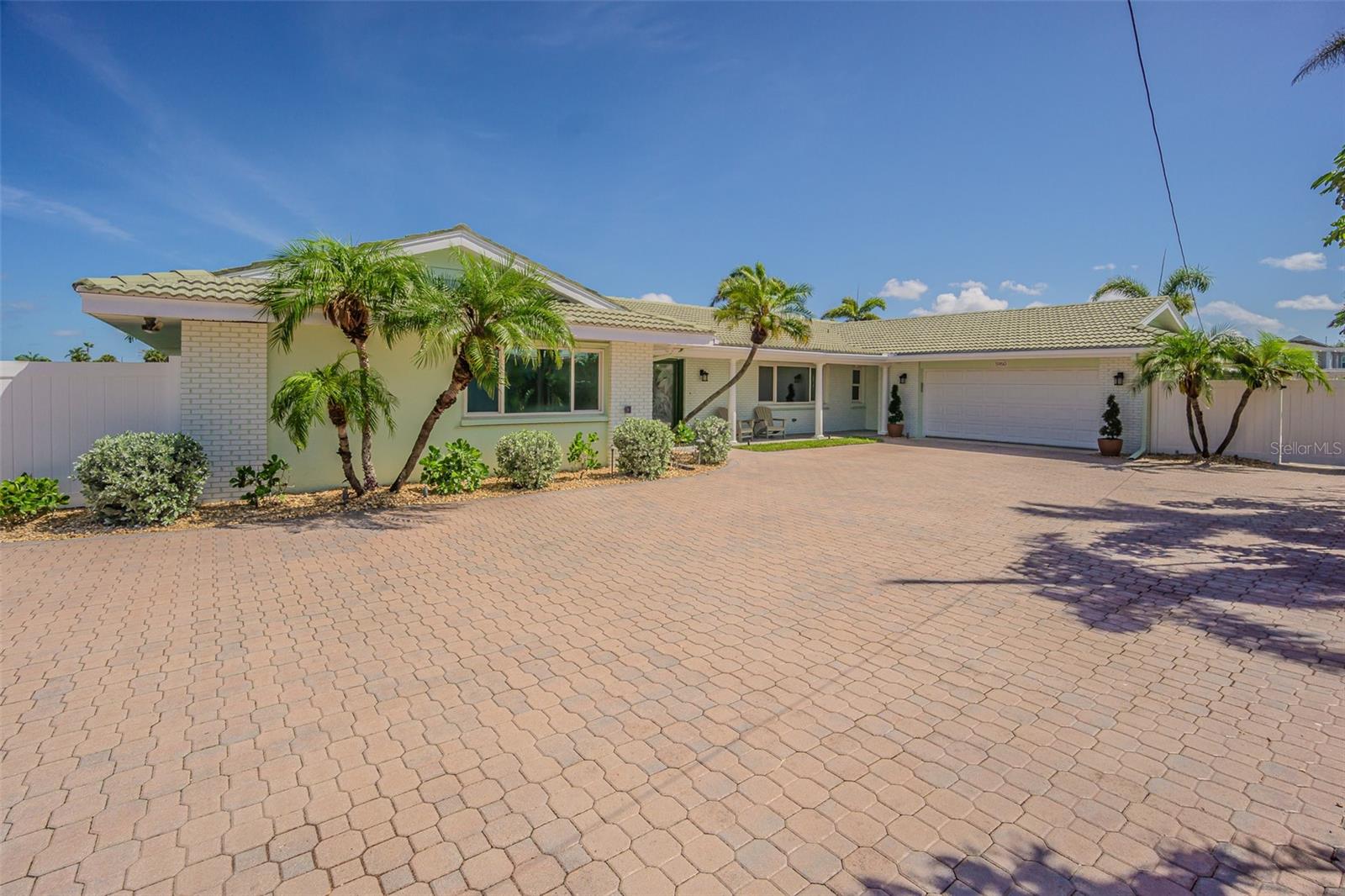 Welcome to coastal luxury living on St. Pete Beach, offering approximately 240 feet of pristine waterfront in the desirable Bahia Shores neighborhood. This beautifully renovated and fully remediated 4-bedroom, 3-bath home boasts 2,900 square feet of refined indoor space designed to showcase breathtaking water views and elegant finishes throughout. Step through the double front doors into a welcoming foyer and be captivated by imported travertine flooring that flows through the living, dining, kitchen, and master suite. Triple-pane impact windows and doors with hurricane shutters provide peace of mind and energy efficiency. The great room, dining room, kitchen, guest suite, and master bedroom all have stunning waterfront views, creating a serene, light-filled environment. The kitchen is a chef’s dream, featuring an expansive island, all-new cabinetry, and brand-new high-end stainless steel appliances. Retreat to the spacious master suite with a luxurious en-suite bathroom, complete with dual vanities, a soaking tub, glass block window, frameless glass walk-in shower, and modern finishes. The laundry room, custom cabinetry, a new washer and dryer, and a quartz countertop with utility sink for added convenience.
Step outside to your private resort-style paradise, including a heated pool with spillover spa, PebbleTec finish, and mosaic mermaid and turtle inlays. The huge pavered deck and Tiki Hut are perfect for entertaining or relaxing in the Florida sun. Boaters will appreciate the dock with a 16,000 lb boat lift, an additional wet slip, jet ski lift, and fish cleaning station—a true waterfront playground. The wide-cap seawall was (installed 2003) to complete this impressive property. All this, just a short stroll to the beach! This exceptional home combines unparalleled water access, high-end finishes, and a prime location to give you the very best in waterfront living.