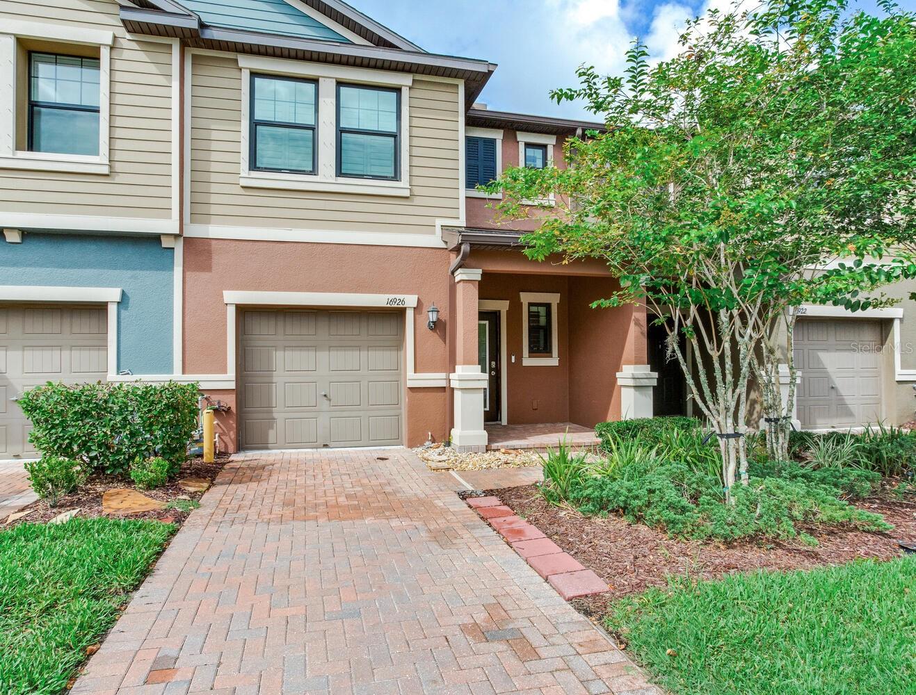 One or more photo(s) has been virtually staged. Built in 2018 - this beautifully upgraded 3BR / 2.5BA townhome in the highly desirable Bexley community of Land O’ Lakes. This 1,601 sq ft residence offers a seamless blend of modern comfort and elegant design. Inside, you’ll immediately notice standout features like PLANTATION SHUTTERS, CROWN MOLDING, upgraded baseboards, custom closet organizers in every bedroom, tile on the first floor, and laminate flooring upstairs. The open-concept main living area is perfect for both everyday living and entertaining. The kitchen is a true highlight, boasting granite countertops, stainless steel appliances including a gas range, closet pantry, and ample cabinetry for storage. All three bedrooms are located upstairs, along with a convenient utility / laundry closet - washer and dryer convey. The spacious primary suite features a custom walk-in closet and en-suite bath, while a versatile loft with built-in desk and shelving offers the perfect spot for remote work or study.
Step outside to the screened lanai with roll-down shades, offering a peaceful space to unwind. Additional upgrades include a water softener, reinforced attic storage, custom garage storage, and a paver driveway. The low HOA covers lawn care, reclaimed irrigation, exterior maintenance, and roof repairs—making for true low-maintenance living. Enjoy access to resort-style amenities: a clubhouse café, heated lap pool, splash pad, state-of-the-art fitness center, dog parks, and miles of scenic walking and biking trails. All just minutes from top-rated schools, shopping, dining, and the Suncoast Parkway for an easy commute. Call today for your private showing.