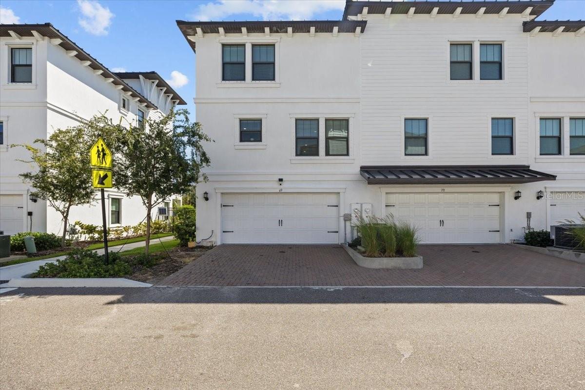A rare end-unit townhome in the heart of Tampa’s Westshore Marina District. This residence offers the best of both worlds: a newer construction home with thoughtful upgrades, and a lifestyle defined by one of Tampa Bay’s most exciting waterfront communities.
Step inside and you’ll notice the difference immediately. The main living area is anchored by a sleek electric fireplace with a Frame TV above, blending art, technology, and comfort. Designer wallpaper, bold light fixtures, and custom details create a home that feels elevated beyond builder-standard finishes.
The open concept kitchen, dining, and living areas make entertaining effortless, while upstairs bedrooms feature spacious walk-in closets and a dedicated laundry suite for convenience. Bathrooms throughout the home have been transformed into design statements—each with its own personality, from sophisticated textures to rainforest-inspired wallpaper.
The garage has been turned into a custom entertainment retreat complete with bar seating, theater setup, and sports-inspired details, showing the flexibility and creativity this property allows.
Community & Lifestyle
Life at Westshore Marina District is about more than just your home, it’s about the lifestyle. This gated community features a resort-style pool, cabanas, and shaded lounges perfect for relaxing weekends. Just beyond your doorstep, you’ll find miles of waterfront walking and jogging trails, boutique shops, fitness studios, and waterfront dining.
The neighborhood is also at the center of Tampa’s rising culinary scene. With Michelin-starred and recognized restaurants like Rocca, Kosen, and Ebbe already making waves, and new top-name concepts rumored to join, the district is poised to become a destination in its own right.
Location That Connects It All
From here, you’re minutes from Downtown Tampa, St. Petersburg, Gulf beaches, and Tampa International Airport. Whether your lifestyle leans toward waterfront recreation, high-end dining, or city convenience, this address delivers it seamlessly.
Why This Home?
Unit 69 isn’t just a home—it’s a choice to live at the intersection of modern design, cultural momentum, and waterfront lifestyle. With its end-unit privacy, curated finishes, and the peace of mind of newer construction, this residence stands out as one of the most unique opportunities in the Westshore Marina District.