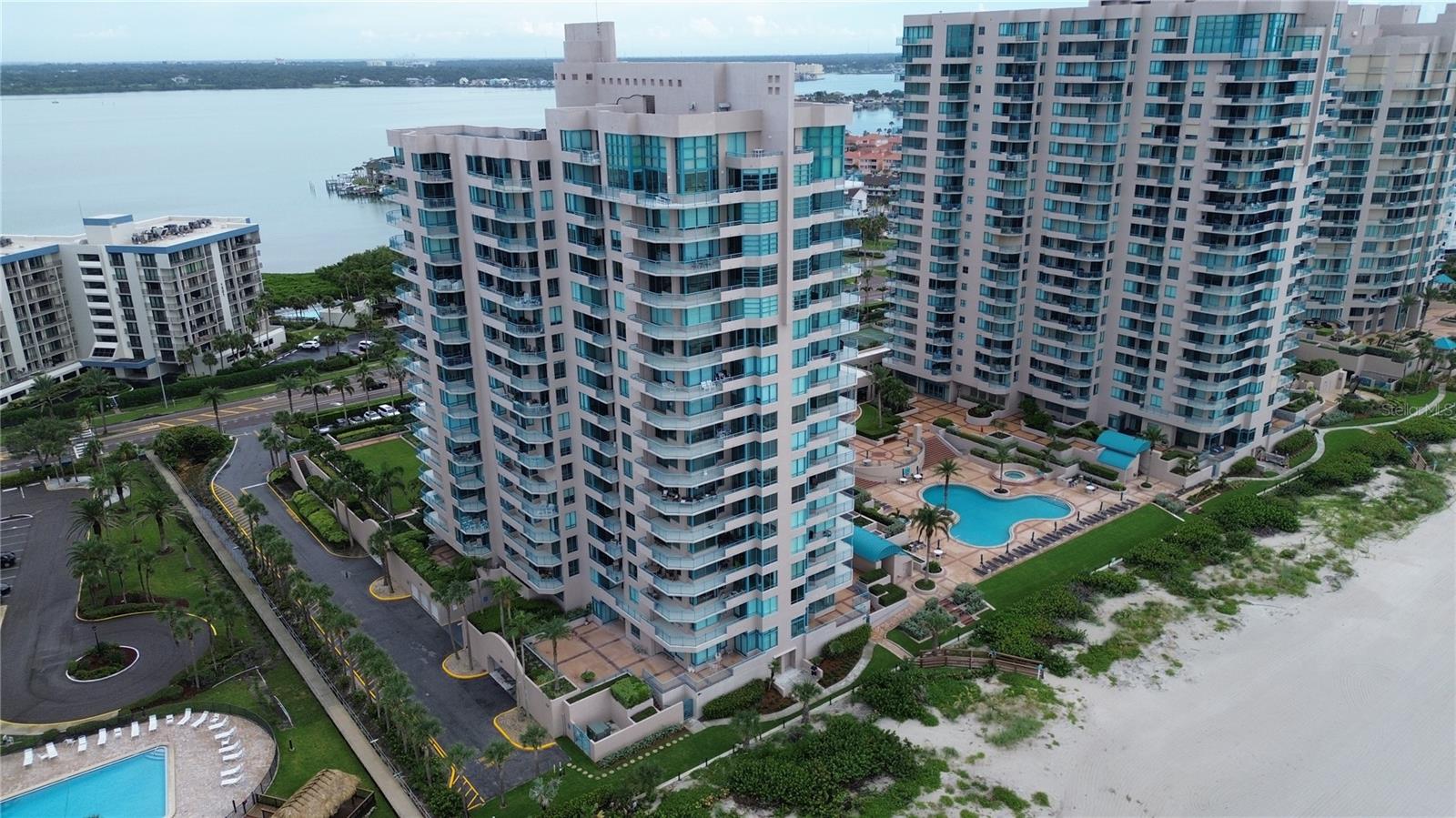 Sun-kissed mornings! Dolphin-watching afternoon!. Firefly-sparkle city lights in Clearwater and over the Intracoastal at night. Welcome to Unit 1104 at Ultimar One on Sand Key—an airy, updated 2-bed, 2-bath retreat perched directly above the sugar sands of the Gulf of Mexico!
Why you’ll love it:
- Front-row panoramic views from almost every room as well as your own large private balcony. Take in the opblue water, wide beach, and endless horizon; turn north for twinkling Intracoastal views after sunset.
- Bright, coastal interior with a smart split floor plan for privacy and effortless everyday living.
- Resort-style living in a gated, guard-attended community with three heated pools (including a lap pool), three tennis & pickle ball courts, fully outfitted fitness center with dry and steam sauna, billiards & club room, putting green, croquet lawn, basketball, on-site managemen all set amid lush tropical landscaping.
Step inside the unit and be instantly greeted by the spacious entryway, and large living room with stunning views. The master and 2nd bedrooms are on opporite sides of the unit providing privacy and functionality. Both bedrooms are large and feature their own spacious walk-in closets with closet systems for optimal storage. The master bathroom features twin sinks, twin lighted mirrors, a large soaker tub and modern shower system.
Ready to step outside? Open the sliders and let the sea breeze roll in. Breakfast tastes better with pelicans cruising by; evenings stretch on the balcony as the sky melts from tangerine to indigo. Inside, the layout keeps the primary suite serene on one side and a comfortable guest wing on the other—perfect for hosting friends or working from paradise. The building’s amenities feel like a private beach club, so your “weekend mode” is always on.
At-a-glance:
- 2 large bedrooms | 2 full baths
- Sweeping views and exposures for Gulf + Intracoastal scenery and soft, all-day light
- Private balcony made for sunrise coffee & sunset toasts
- Covrered parking + a large storage closet in building for your beach gear, seasonal decorations or household goods
- 24/7 guard-gated entry peace of mind
The Ultimar advantage:
Ultimar One was solidly built in 1991 by US Steel. This concrete and steel high-rise is built to last and is one of Sand Key’s most coveted beachfront towers.
The Ultimar complex is an iconic trio of towers on Sand Key’s beachfront, celebrated for its walk-out-to-the-sand lifestyle and rich amenity slate—clubroom with full kitchen & media, fitness center with steam/sauna, multiple pools (lap & resort-style), tennis, pickle ball, putting green, croquet, basketball—all within a friendly, well-run community.
Location, location… vacation
Step onto the sand in seconds. Stroll to Sand Key’s cafes and boutiques. Zip over the bridge to Clearwater Beach’s dining scene, marinas, and live-music spots—then come home to tranquil, residents-only shoreline. It’s the sweet spot between resort energy and residential calm.
Ready to make every day a beach day? Unit 1104 at Ultimar is the easy-breezy, toes-in-the-sand life you’ve been manifesting—wrapped in comfort, security, and postcard views.