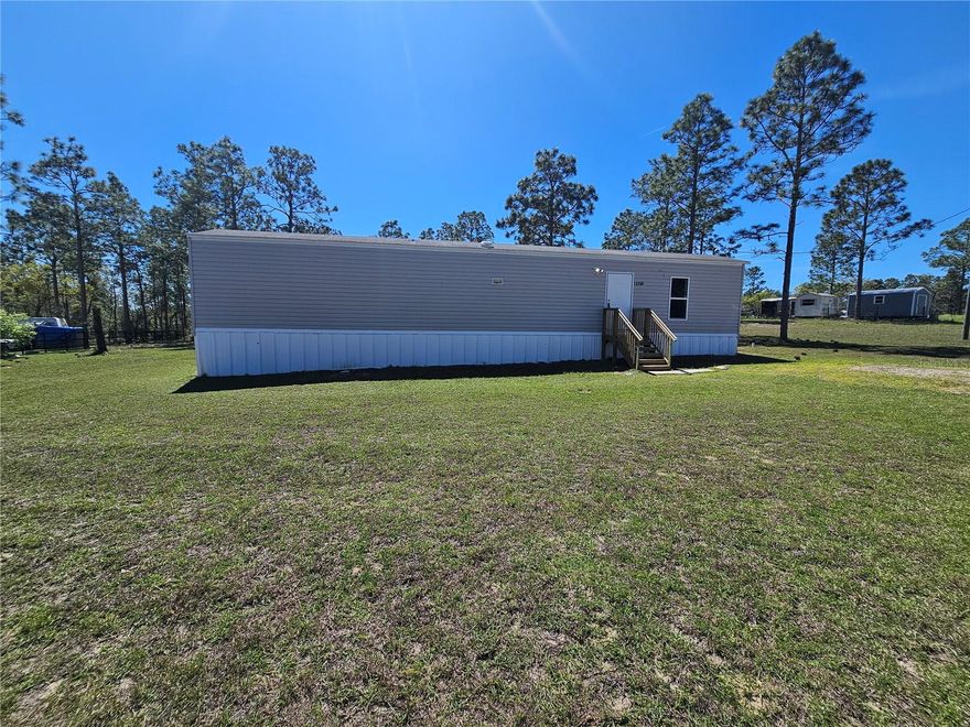 Affordable country living in Williston Highlands! This 2-bedroom, 1-bath single-wide mobile home offers 720 square feet of living space on a full acre, providing plenty of room for gardening, animals, or simply enjoying wide-open space and privacy. Located in an area with steady, slower-paced growth, this property offers a relaxed rural setting while still being within reasonable driving distance to Williston, Ocala, and Gainesville for shopping, dining, and everyday needs. Ideal for investors, rental potential, or anyone seeking an affordable place to call home with land and flexibility. Cash only sale.