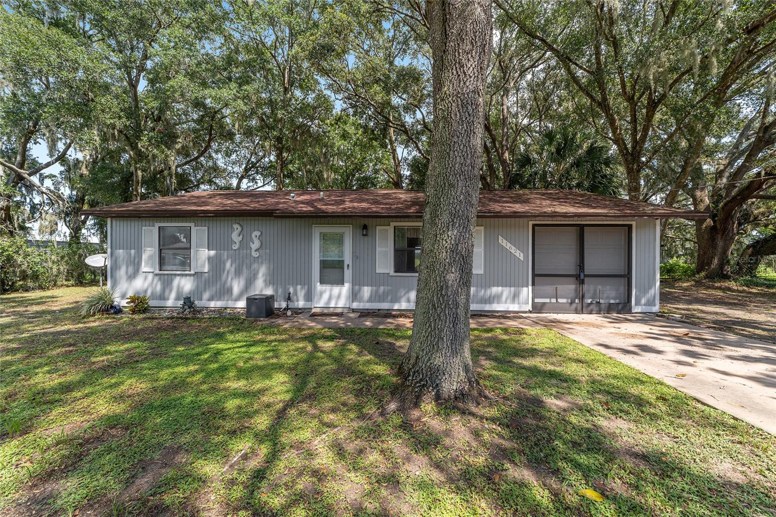 This quaint home is located on .38 acre overlooking a pasture. Dunnellon Oaks is conveniently located off HWY 484 with easy access to Ocala, the Rainbow River, Crystal River, or the World Equestrian Center. With your personal touches this home has the potential to be something special! With nearly 900 square feet of living space this property features 2 bedrooms, 2 bathrooms, and a one car garage. The primary shower has been tastefully updated. Your hall bath is conveniently attached to bed 2. The laundry room has a spacious pantry and second refrigerator. The outdoor living space features a 14x11 east facing screened porch for your plants or morning coffee. The large shed offers ample space for storing lawn equipment or other toys.