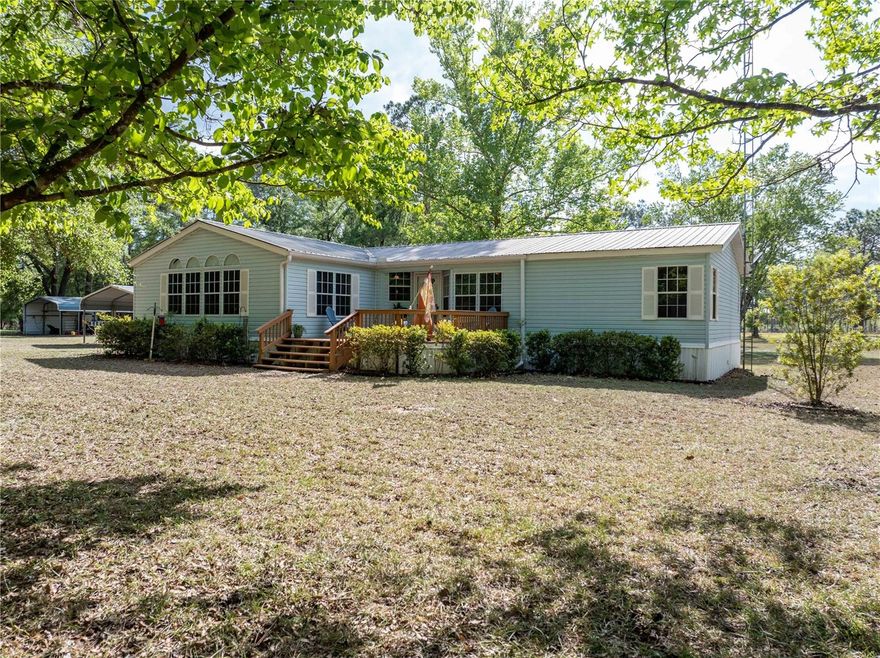 Check out this Beautiful Light and Bright Triple Wide on 10 Partially Cleared and Landscaped Acres w/ Gated Entry! Home has a Large Updated Kitchen w/ Deep Pantry and Abundant Counter Space for Entertaining and a Breakfast Area just off the Family Room that has Gorgeous Windows Looking Out at Nature and a Wood Burning Fireplace for those Cool Evenings! Separate Formal Living Room w/ Dining Area! This Home Features a Split Floor-Plan that has a Large Master w/ a Walk In Closet and Large Bathroom!  Sit on your 6x20 Rear Screened Porch and Watch the Deer and Turkey come through! Property features Park Like Landscaping, a 14x16 Front Deck,  12x30 Metal Work Shop and 18x20 Carport w/ Slab! Plenty of Room for your Animals and Close to the Suwannee River and Springs! Not in a Flood Zone or Subdivision! Come see This Immaculate Home, Ready to make it Your Own!