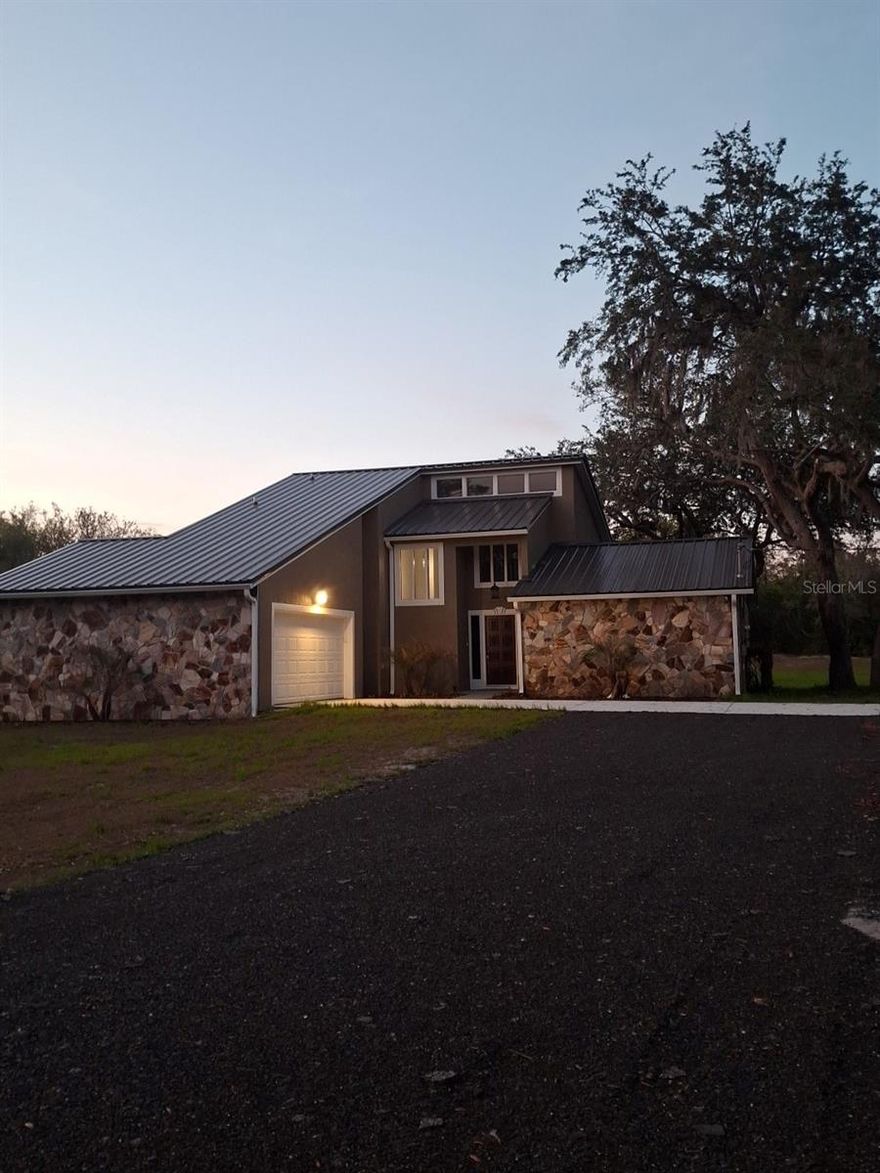 I JUST CAN'T SAY ENOUGH ABOUT THIS HOME. WE HAVE LOCATION, IT HAS THE MOST SCENIC ROAD IN WEST VOLUSIA COUNTY. IT OFFERS THE NEW BIKE PATH / NATURE TRAIL FROM DEBARY TO THE EAST COAST.  CLOSE TO ALL SCHOOLS, EASY ACCESS TO STATE ROAD 415, 46, 417,44, I-4, I-95  SANFORD/ORLANDO INTERNATIONAL AIRPORT, MAYTOWN ROAD AND LET'S NOT FORGET THE SAINT JOHNS RIVER WHICH WILL TAKE YOU ANYWHERE IN THE WORLD.
BUT ONCE YOU OWN THIS HOME YOU WILL NEVER WANT TO LEAVE.  THERE IS NO OTHER LIKE THIS ONE. IT'S A CUSTOM-BUILT HOME FROM ONE OF THE BEST BUILDERS AROUND. ALL NEW TEXTURED CEILINGS WALLS AND PAINT THROUGHOUT, NEW KITCHEN 2 LAZY SUSANS BIG DEEP SINK ALL WOOD SOFT TOUCH CLOSING CABINETS WITH NEW STAINLESS STEEL APPLIANCES AND A EXTRA LARGE PANTRY.  ALL NEW CAN LIGHTING AND STONE COUNTERTOPS. SNACK BAR COUNTER NEXT TO THE DINING ROOM WITH SLIDERS TO GO OUTSIDE TO A COVERED PATIO FOR GRILLING OR JUST TO RELAX.   ALL 3 BEDROOMS WILL HOLD KING SIZE BEDS AND STILL LOTS OF ROOM LEFT.  THE 2ED BEDROOM HAS ITS OWN NEW SLIDERS TO GO OUT ON IT' OWN PATIO TO THE BACK YARD.  THE PRIMARY BEDROOM UP STAIRS OFFERS ITS OWN NEW SLIDERS THAT OPEN UP ONTO A PRIVATE BALCONY OVERLOOKING THE HOLE BACK YARD WITH ITS BEAUTIFUL OAK TREES AND 2 LARGE WINDOWS FOR LOTS OF LIGHT, AND THE BATHROOM HAS A LARGE WALK IN CLOSET AND ALSO A LARGE LINEN CLOSET NEW LARGE TUB AND SHOWER, DUAL SINKS AND LARGE WINDOW IT'S LIKE YOU NEVER NEED A LIGHT ON IN THE DAY. ALL NEW SWITCHES & COVERS THROUGHOUT THE HOME.  THE LIVING ROOM HAS LARGE SLIDERS THAT OPEN UP TO YES ANOTHER PATIO. INSIDE IS THE MOST BEAUTIFUL STONE FIREPLACE I HAVE EVER SEEN I COULD LOOK AT IT ALL DAY AND LOOKING UP AT THE LOFT, WITH WOODEN SPINDLES AND WINDOWS.   THIS 2 STORY IS SUCH AN EYE CATCHER IT'S A MUST TO SEE AND IT SITS ON 2.5 ACRES +- AND ITS ONLY HALF CLEARED.  SO MUCH ROOM THE IDEAS ARE ENDLESS... YOU WILL NEVER HAVE ANY PROBLEM PARKING HERE...    City Water and Septic tank!   Survey in office!    Metal roof installed in 12-2025.    R V.   Hookup and pad. ! YES HORSES AND LIVE STOCK WELCOME. TRUCKS AND EQUIPMENT PLENTY OF PARKING.