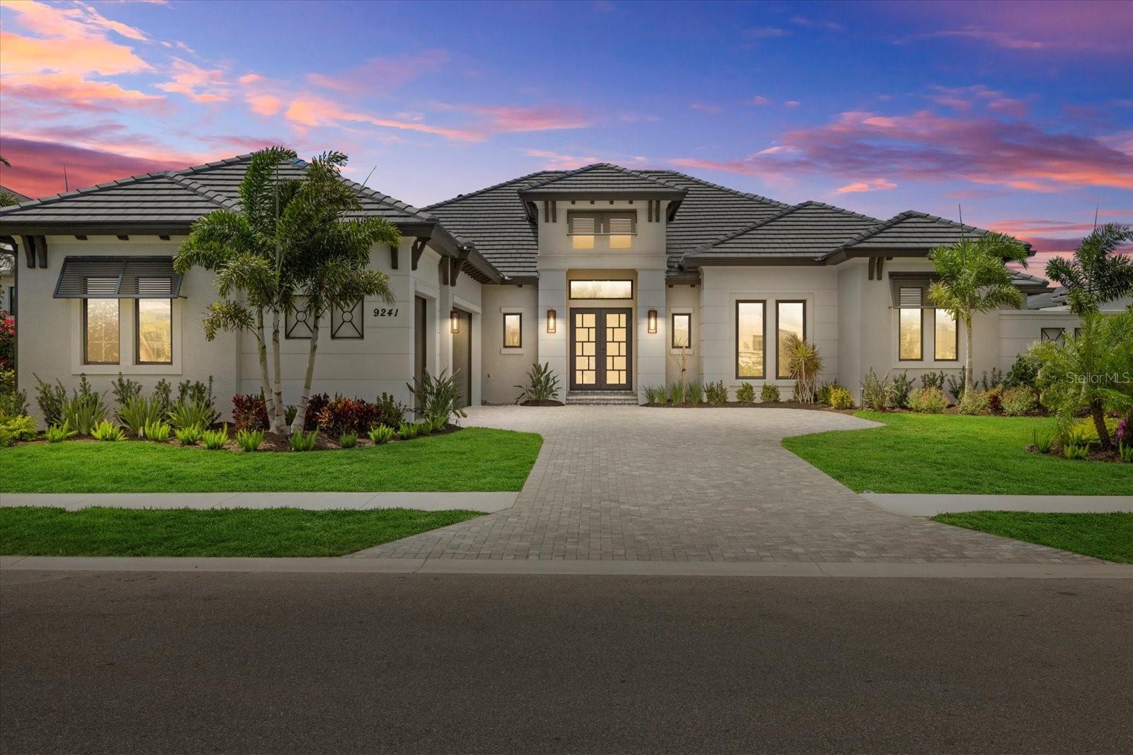 Under contract-accepting backup offers. One or more photo(s) has been virtually staged. Welcome to The Milina, a Contemporary West Indies masterpiece nestled in the highly sought-after Skye Ranch community. This stunning home by John Cannon Homes offers an unparalleled combination of elegance and modern sophistication. Featuring a captivating open floor plan filled with character, color, and light, The Milina is one of John Cannon Homes' most contemporary designs to date. The home’s spacious layout includes Cypress beamed ceilings and a Ledgestone-tiled wall with a 74” linear ice ember fireplace, creating a warm, inviting atmosphere that perfectly balances style and comfort. Expansive disappearing glass walls transition the great room to the generous outdoor living spaces, allowing for seamless indoor-outdoor flow—ideal for entertaining and enjoying Florida’s beautiful weather.
The home’s contemporary kitchen and dining areas are designed for both warmth and functionality. Equipped with top-of-the-line GE Monogram appliances, the kitchen is a chef’s dream. The master suite is privately situated on one side of the home, offering a sensual retreat with its own outdoor courtyard shower, providing a truly luxurious, spa-like experience. Elegant, oversized wood and gold chandeliers add a touch of glamour, and soft accents in creamy beige and Cerulean blue complement the modern aesthetic throughout the home.
In addition to the 4 bedrooms, 4 bathrooms, and study (complete with a closet), there is a versatile bonus room that offers endless possibilities—whether used as a home office, playroom, or media room, it adds even more flexibility to this already spacious home. The 3-car garage provides ample storage space, while the total offers plenty of room to spread out. The expansive lanai, with a full outdoor grill and a heated saltwater pool, making it the perfect spot to unwind or entertain guests.
The Skye Ranch community offers an exceptional amenity center, which includes an indoor gym, basketball courts, a game room, a café, multiple pools, a splash pad, tennis courts, pickleball courts, and walking trails. The home is located in a top-rated school district, providing easy access to the new K-8 Skye Ranch School.
For added peace of mind, the home comes with a 10-year structural warranty from John Cannon Homes that is fully transferable. Additionally, the home is protected by a termite warranty from Massey Pest Control, which runs through the beginning of 2026, with the option to renew thereafter.
The Milina represents a perfect blend of contemporary luxury and functional design, situated in one of the most desirable communities in the area. Live the dream in this exceptional home, where every detail has been thoughtfully curated to offer a lifestyle of comfort and sophistication.