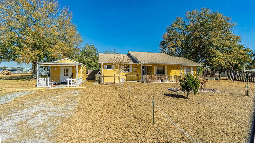 Welcome to your own PRIVATE slice of country living!  Nestled on just under an acre, on a quiet private street, this charming 1992 solid block home offers room to roam and freedom—without the restrictions of an HOA or CDD fees. REST EASY on your Rocking chair front porch with roll down privacy sun shades! Great Curb appeal with a New dimensional shingle roof, Landscaped lawn and quaint setting! With approximately 1,300 square feet of living space plus a 240-square-foot, air conditioned Florida/sunroom (12’x20’), this well-maintained 3-bedroom, 2-bath split floor plan provides space, privacy, and versatility. Light, Bright and OPEN floorplan boasts Vaulted ceilings which enhance the spacious living room, while laminate flooring flows through the main living areas and kitchen, which features newer appliances, loads of cabinets and an adjacent dining area ideal for gatherings. The owner’s suite includes an en-suite bath with a walk-in shower, and an exit door to access the she shed or backyard. The secondary bedrooms... located on the opposite side of the home for added privacy... feature ceiling fans and durable vinyl flooring. A second bath with tub/shower combination is conveniently located near the guest rooms, and the home is wheelchair accessible through the main living areas and primary bathroom.  Inside laundry room with window overlooking backyard includes the newer washer and dryer with extra storage space. Relax outside and enjoy the expansive backyard, complete with a fenced privacy area perfect for pets, playground, garden area, camper parking and clean out, or a future pool. The impressive 85-foot driveway accommodates parking for a dozen or more vehicles, making it ideal for entertaining. There’s room for all your toys with an RV/travel trailer hookup offering water, septic, and 50-amp service. Two sheds provide exceptional flexibility—one currently used as a meticulously maintained she-shed/craft room or home office, perfect for remote work or hobbies, and another for tools and storage. Features and updates include a Brand New amber shingle ROOF (2025), Washer & Dryer (2026), Refrigerator (2021), HVAC (2017), plumbing updates (2019), 40 gallon Rheem water heater (2017), a 250-foot submersible well pump delivering exceptional Zephyrhills water and a well and septic system with drain field approximately 10 years old and regularly maintained. With no water bill, monitored alarm system that conveys, and the freedom to enjoy bonfires, boats, RVs, and gatherings outside city limits, this peaceful property offers privacy, great neighbors, and room to truly live! Picket fence on the covered front porch is a great place to unwind, listen to the birds, or star gaze! Why settle for a cramped subdivision with all the rules, when you can have space, serenity, and endless possibilities? MUST SEE inside and explore all the opportunities inside and out! CALL TODAY!