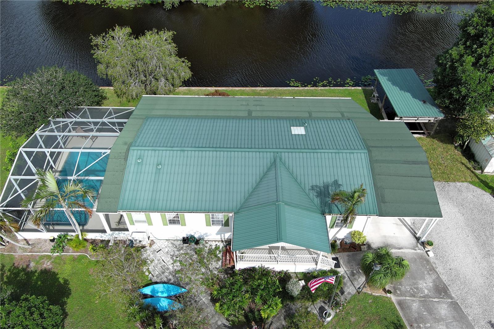 WATERFRONT POOL HOME sprawling over .26 acres situated on a cul-de-sac and converging canals. Relax or exercise in the lavishly inviting 12x24 sparkling pool with non-skid, cool-coated surface under a fully enclosed patio with bona fide privacy. Any boat will appreciate being on the electric lift shaded under the boat slip, before a day of leisure or fishing on Lake Okeechobee. Rest-assure the impressive 220 ft of strong seawall will last a lifetime. Pull a camper right up the 2nd driveway for full RV hook-up (2nd septic system). Zoned irrigation will keep landscaping and green & lush. Take in the calming view of the waterfront from the 12x45 Florida Room (mini-split AC). Appreciate the ample soft-close kitchen cabinets, granite countertops and updated baths. Roof 2018. Avocado trees too!