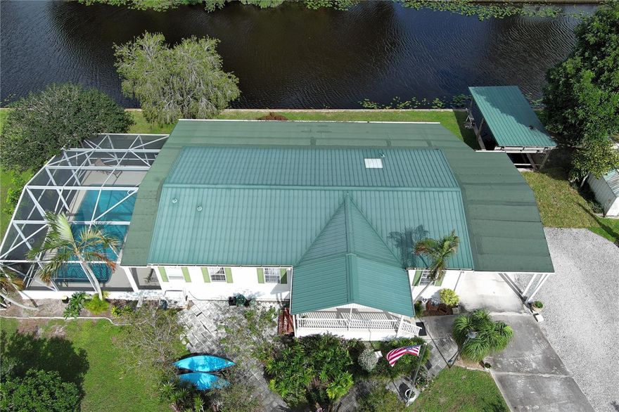 WATERFRONT POOL HOME sprawling over .26 acres situated on a cul-de-sac and converging canals. Relax or exercise in the lavishly inviting 12x24 sparkling pool with non-skid, cool-coated surface under a fully enclosed patio with bona fide privacy. Any boat will appreciate being on the electric lift shaded under the boat slip, before a day of leisure or fishing on Lake Okeechobee. Rest-assure the impressive 220 ft of strong seawall will last a lifetime. Pull a camper right up the 2nd driveway for full RV hook-up (2nd septic system). Zoned irrigation will keep landscaping and green & lush. Take in the calming view of the waterfront from the 12x45 Florida Room (mini-split AC). Appreciate the ample soft-close kitchen cabinets, granite countertops and updated baths. Roof 2018. Avocado trees too!