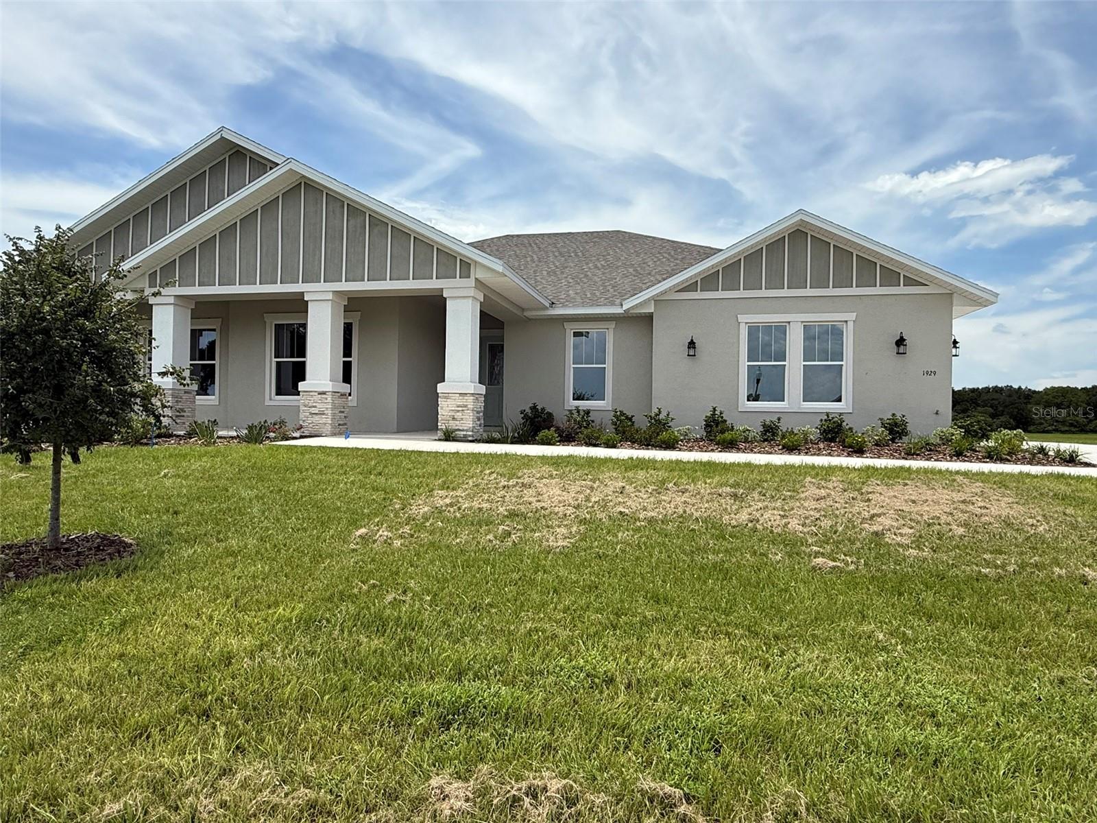 One or more photo(s) has been virtually staged. WELCOME TO THE VENICE MODEL BY THE AWARD WINNING BUILDER OF SPIRE HOMES, LLC With a covered, wraparound porch in front and two separate lanais in back, the Venice offers multiple options for entertaining and relaxing. Step inside you’re welcomed into a foyer leading to a great room, decorative tray ceilings. The main living area is the heart of the home, filled with sunlight from sliding glass doors to one of the lanais. The centrally located kitchen features a walk-in pantry, high-end counters and cabinetry, and a large island with seating. Steps away from the dining area a convenient utility room with laundry facilities and garage access. There are three private bedrooms, each in their own corner of the home, each near a full bathroom. The owner’s suite has a tray ceiling in the bedroom and two spacious walk-in closets. Luxury amenities in the bathroom include dual vanities, a walk-in shower, and a sunlit soaking tub. Another retreat is the large den, accessed by French doors in the front of this amazing home.