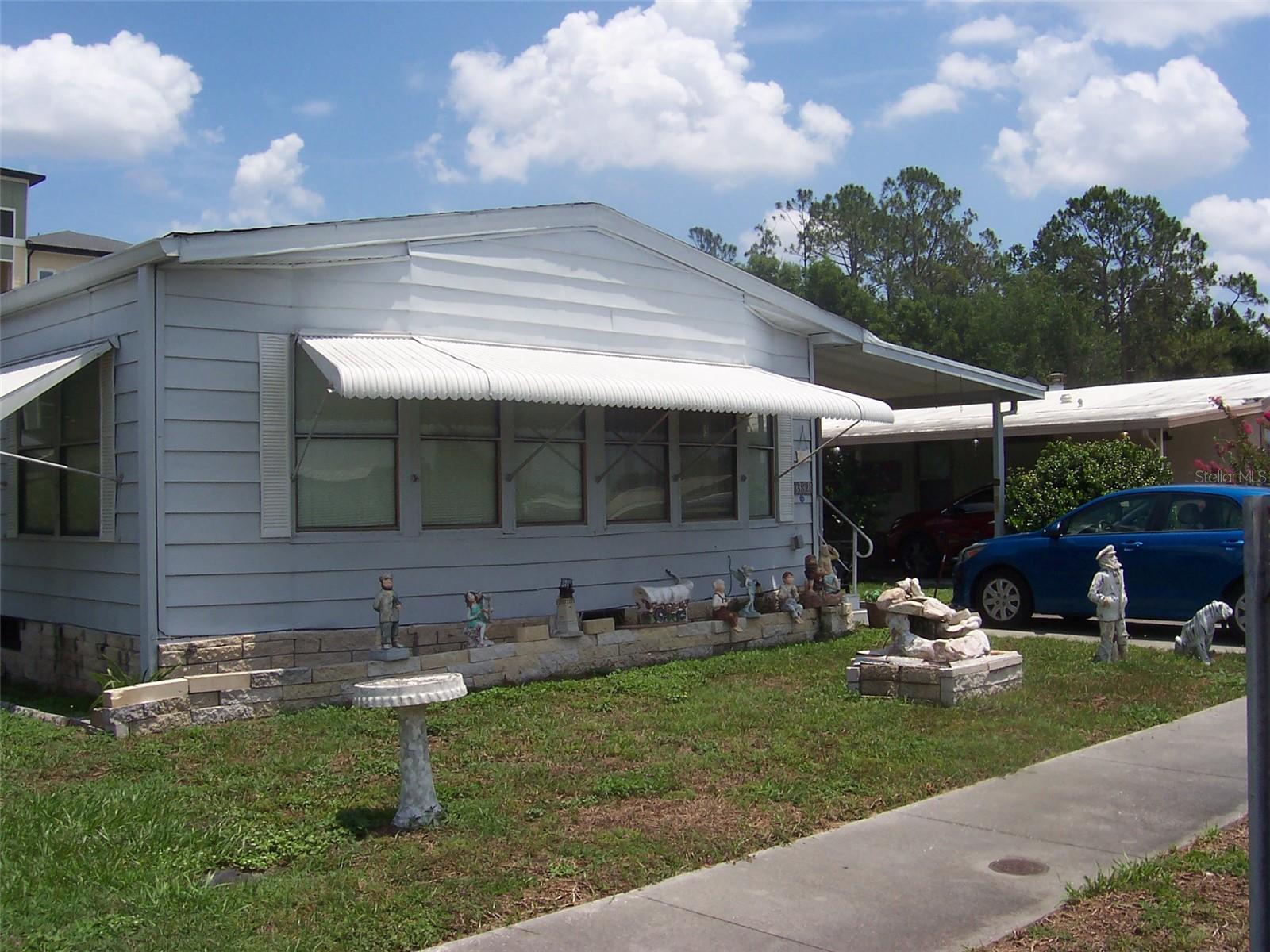 Check out the square footage in this 2 bedroom, 2 bath home. 1440 of heated and cooled square footage! Owner is in the middle of packing up boxes are everywhere! It's in need of some updating but once done what a show piece. This is a great doublewide with a front family room plus a formal living room. Kitchen is a great size and loaded with cabinets. Kitchen includes range, refrigerator and dishwasher. Large Dining room is convenient to kitchen and offers space for a very large table plus it has a built-in hutch with glass doors and plenty of cabinets underneath. Owner suite has double mirrored closets with an ensuite bathroom with walk in shower.
Bathroom also offers a nice built in vanity area with space for a chair. Guest bedroom is spacious with double closets as well and located right across from guest bath featuring tub/shower combination. There is no lack of space in this home! There is a nice storage room located off the hallway that has a built-in closet and plenty of room for a great pantry or an entry way off the Florida Room. Walk through this room and open the door to the glassed in Florida Room which flows into a back laundry room and storage/workshop area. House needs a bit of updating but considering the square footage well worth the time and effort. Located in Terrace Park Estates which is a 55+ community. Community offers a nice clubhouse, shuffleboard courts and pool area. Park is deed restricted however you own the home and land. Low HOA fees!!
