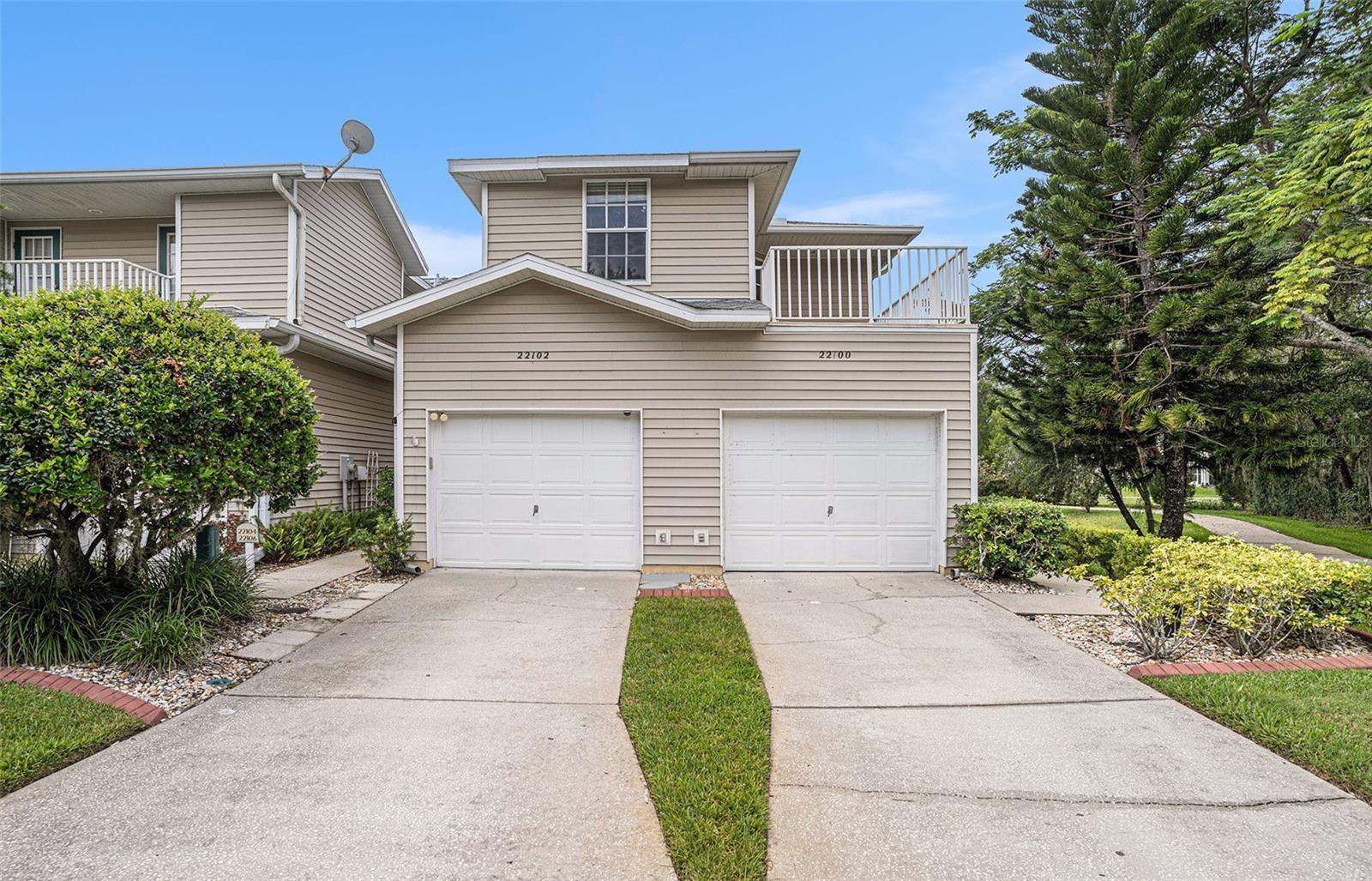Discover the perfect blend of comfort, privacy, and convenience in this beautifully maintained corner-unit condo, located in the highly desirable gated community of Heron Cove. From the moment you walk in, you’ll notice the natural light pouring in through large windows, highlighting the vaulted ceilings and open floor plan that make this home feel airy and spacious. Enjoy peaceful views of the conservation area and tranquil pond from two different balconies, creating a serene atmosphere that’s rare to find. The large living and dining area flows seamlessly into the kitchen, making it ideal for both everyday living and entertaining guests. The spacious primary suite offers a private retreat with an en suite bath featuring a walk-in shower, a separate water closet, and his and hers vanities. The second and third bedrooms are also generously sized and share an updated bathroom positioned conveniently between them. Step outside and relax on not one, but two private balcony patios, the perfect spots for morning coffee or unwinding after a long day while surrounded by nature. This home is perfectly situated with easy access to I-75, I-275, the Suncoast Parkway, and Dale Mabry Highway. You’re just minutes from top shopping destinations like The Shops at Wiregrass and Tampa Premium Outlets, as well as great dining, healthcare facilities, and more. If you’re looking for low-maintenance living with beautiful views and an unbeatable location, this Heron Cove gem is a must-see.