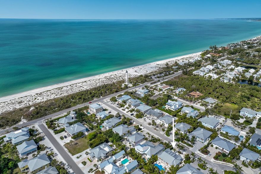 Boasting an idyllic location in the heart of Boca Grande on Gasparilla Island, this beautifully appointed 2016 home just south of town presents unparalleled opportunity for those seeking the perfect blend of elegance, comfort, and coastal charm with the benefits of newer construction.  This four bedroom, four bathroom residence is beautifully positioned on a 80’ x 135’ south facing lot creating an incredibly generous and private outdoor pool space with sunshine all day long!  As you enter this Island home you’ll appreciate the maintenance free composite decks and freshly sealed tongue and groove outdoor cypress ceilings.  Once inside, the high ceilings, large impact glass windows, and open floor plan with gorgeous European white oak engineered flooring throughout, creates an airy and welcoming atmosphere.  The three dormers over the living room space create eye catching architectural interior design, soaring ceilings, and the natural light abounds into the living room that also features recessed sliding glass doors to the outdoor deck overlooking the pool. The chef’s kitchen features luxury Thermador appliances including a Professional Series 6 burner gas range and double oven, refrigerator, dishwasher, and U-Line wine refrigerator.  The kitchen island is graced with seating for four, a timeless marble countertop and white porcelain apron front sink with quartz countertops on the perimeter.  Retreat to the spacious primary suite with modern bespoke bathroom with a frameless shower door, soaking tub, walk-in closet, and charming french doors that lead to the exterior deck overlooking the tropical outdoor oasis. This thoughtful split floor plan offers three guest bedrooms and bathrooms with a fun bunk bedroom en-suite featuring custom lighting with USB outlets/charging ports for each bed space.  The exterior of the home is protected with impact glass windows and doors, Hardie-board siding and soffits, and a 2016 metal roof. Relax by the 36’ x 14’ pool with sun shelf or entertain on the expansive patio with propane powered grill and fire pit all while surrounded with mature, tropical landscaping, providing a true, private, Island paradise.  The recently painted garage bays offer freshly coated epoxy floors and owners and guests love this beautiful Island street with buried utilities.  With views of the iconic range light from the semi-circular driveway, beach access at the end of the street, close proximity to town, restaurants, shops, and farmer’s market, this timeless Island residence ensures a seamless blend of convenience and luxury.