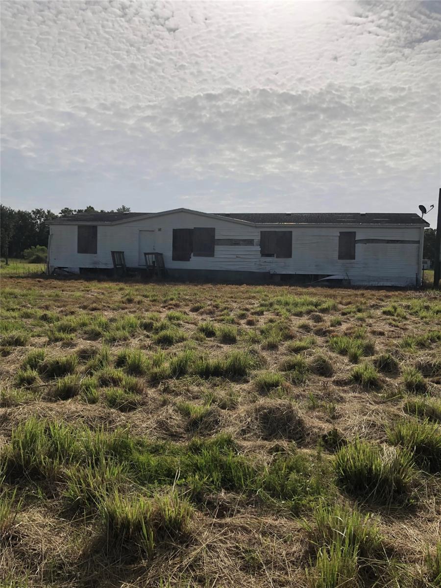A spacious 3-bedroom and two full bathrooms in a double-wide manufactured home on nearly 5 acres. It has much renovation potential and is ideal for investors or someone seeking a rural property to renovate. Offered in its current “as-is” state, this property provides a blank canvas with significant acreage, privacy, and potential upside. This property can be for residential use, livestock, gardens, or building additional structures.