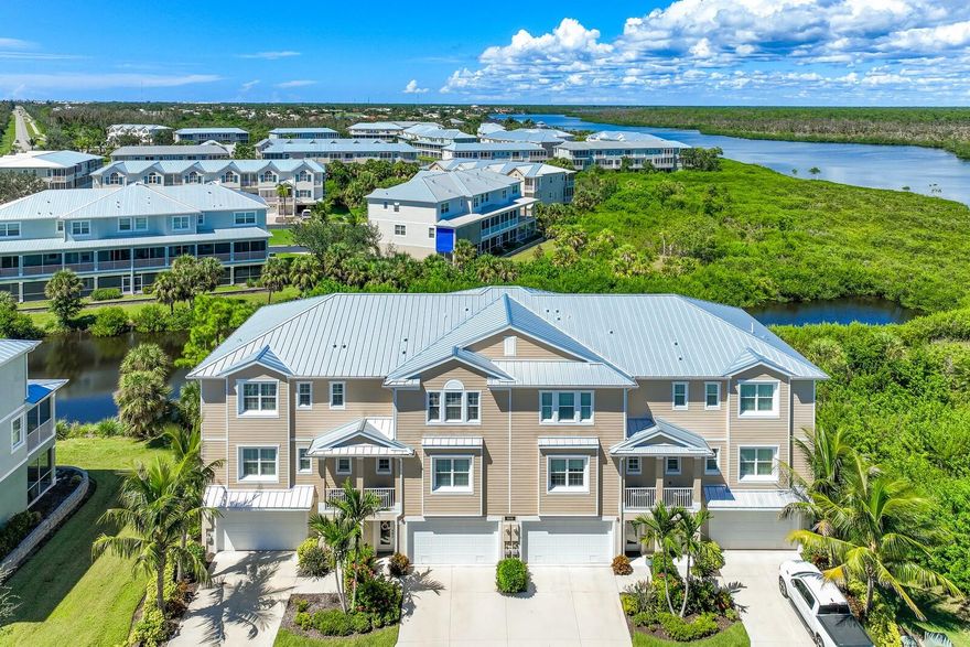 This stunning, rarely available end unit townhome, built in 2020 and meticulously maintained, is nestled in the Landings at Coral Creek, a prestigious gated community just minutes from the pristine shores of Boca Grande. Situated on a tranquil cul-de-sac, this exquisite residence boasts breathtaking views of Coral Creek and offers 2,620 square feet of luxurious living space. Inside, you'll find 3 spacious bedrooms, each featuring ensuite baths, along with an optional 4th bedroom or den. The main living area showcases an open floor plan filled with natural light, seamlessly connecting to a beautiful kitchen adorned with elegant granite countertops, a stylish tiled backsplash, and solid wood cabinetry. Step out onto one of the two expansive screened lanais, where you can relax and soak in the serene views and vibrant wildlife of Coral Creek. The main floor also includes a den or 4th bedroom and a convenient half-bath. Upstairs, the primary bedroom offers captivating water views, complemented by a spa-like master bath with dual vanities, a large soaking tub, a separate shower, and a generous walk-in closet. Down the hall, two guest suites feature their own ensuite full baths, ensuring comfort and privacy for family and friends. Natural light pours in throughout the home and is enhanced by beautiful plantation shutters. A whole house elevator provides easy access to all floors. The spacious garage accommodates up to 4 vehicles and includes a storage closet and an additional large, screened lanai. Recent upgrades include a new tiled lanai (2025), dishwasher (2024), roof (2023), soffits (2023), under cabinet lighting, custom soft close cabinetry in the laundry and closet, and additional electrical outlets in the garage. Both lanais are fitted with no-see-um screens, creating the perfect setting for enjoying wildlife and breathtaking sunsets. The Landings at Coral Creek offers exceptional amenities, including a resort-style pool, community dock, fitness center, tennis and pickleball courts, kayaking, and fishing. This community offers planned social events in their sophisticated clubhouse where you can enjoy a library, fireplace, TV room, and dining area.