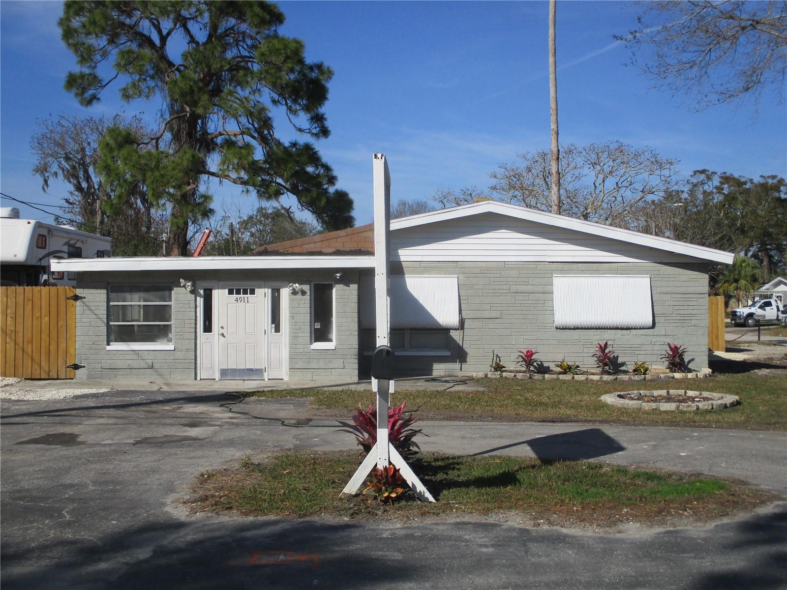 This property was a souvenir shop for 40 years and was zoned commercial at the time the current owner purchased it. The county has removed the commercial zoning. It may be possible to reestablish the commercial zoning. It has an approximately 600 sf newly remodeled 2 bedroom 1 bathroom house that is currently rented out. There is an approximately 300 sf attached office or retail space with a 1/2 bathroom. There is detached 16x16 garage. There is an large asphalt circle driveway. There is tons of storage area for equipment. The Listing agent is the owner and will have to be present for all showings. This property was flooded from Hurricane Helene. It has been partially repaired. The pictures provided are of its current condition. CASH ONLY