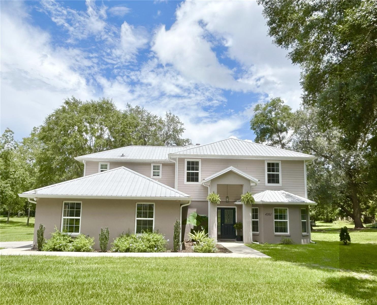 OPPORTUNITY KNOCKS... THIS EXCITING EXAMPLE OF POSSIBILITY...Just past the Downtown of Williston, FL., In the serenity of, and beneath the Canopy of Ancient Oaks, this country road brings you home. This exquisite 5 bedroom/4 bathroom home sits nestled on a beautifully cared for and improved, 5.86 acres, with a variety of trees, including a grove of mature and yielding Pecan. Amid your Equine neighbors and conveniently located close to all necessity, this home offers the option and elegance of country living paired with the ease of accessibility of in-town living. A 40x40 leveled and pounded pad awaits the construction of your future Barn, within the spacious and fenced acreage that the owners have opened up, even further usability, through clearing, creating an absolutely enchanting, rolling area and a blank canvas for future creativity.