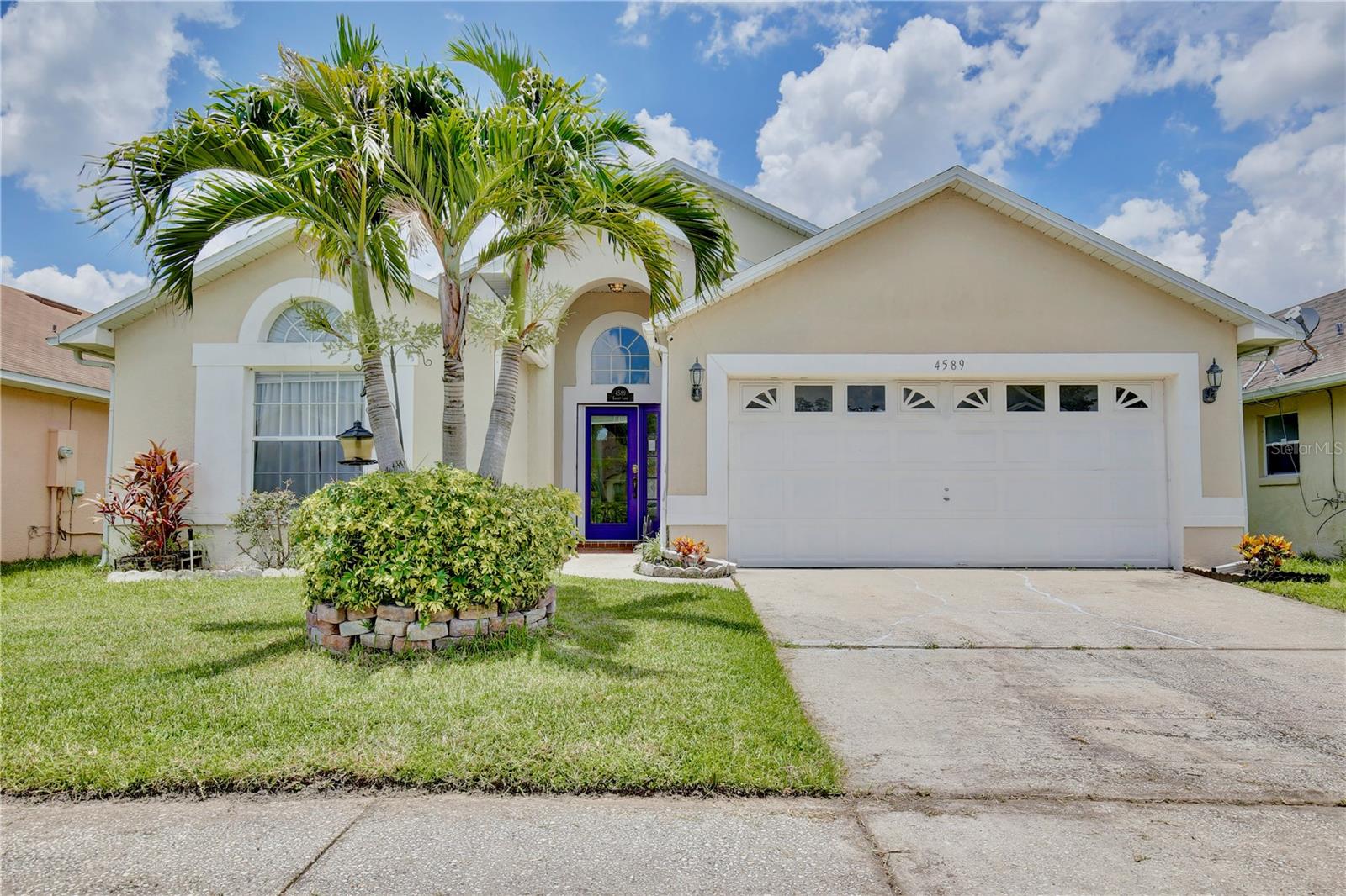 Discover the epitome of Florida living in this beautiful three-bedroom, two-bathroom residence, where every day feels like a vacation! Boasting curb appeal with landscaping and tropical palm trees, this house welcomes you through a cheery blue door into an elegant interior accentuated with arched walkways, stately columns, crown molding, cherry wood-style floors, and vaulted ceilings that amplify the natural light. The ROOF was replaced in 2017, offering peace of mind and added value. Host guests effortlessly in the stunning dining area where a radiant chandelier sets the tone, seamlessly transitioning into the living room framed by graceful archways. The generously sized kitchen is a chef's delight with its sleek granite counters, stainless steel appliances, glass door cabinets, pantry storage, and breakfast nook for casual dining. The living room features an accent display wall and provides an inviting atmosphere with picturesque views of the serene pool through sliding glass doors. Find solace in the light and airy primary suite adorned with elegant wainscoting and trim, tranquil pool vistas, and a walk-in closet with custom built-ins. The primary bath offers dual sinks, granite counters, a bathtub, and a glass door shower. A versatile bonus room with double door entry offers serene pool views, perfect for a home office or creative space. Two inviting guest bedrooms with vaulted ceilings are located on each side of the guest bath, featuring a granite counter vanity and tub/shower combo. Outside, relax under the shade of the covered patio with wood plank ceilings and take a leisurely swim in the stunning lagoon-style pool. Community amenities include a playground, picnic area, pickleball court, and a pool with water vistas. With its proximity to Disney World, Publix, Walmart, Kissimmee Gateway Airport, and Highway 192, this home is a true retreat. Experience the best of Florida leisure—feed gators at Gatorland, enjoy retail therapy at The LOOP, revel in Old Town's car show parade, and embrace the magic of Disney World. Home is also zoned short term rental and can be used for holiday rentals. Don't miss the opportunity to make this dream home your reality. Schedule a showing today and claim this gem as your own!