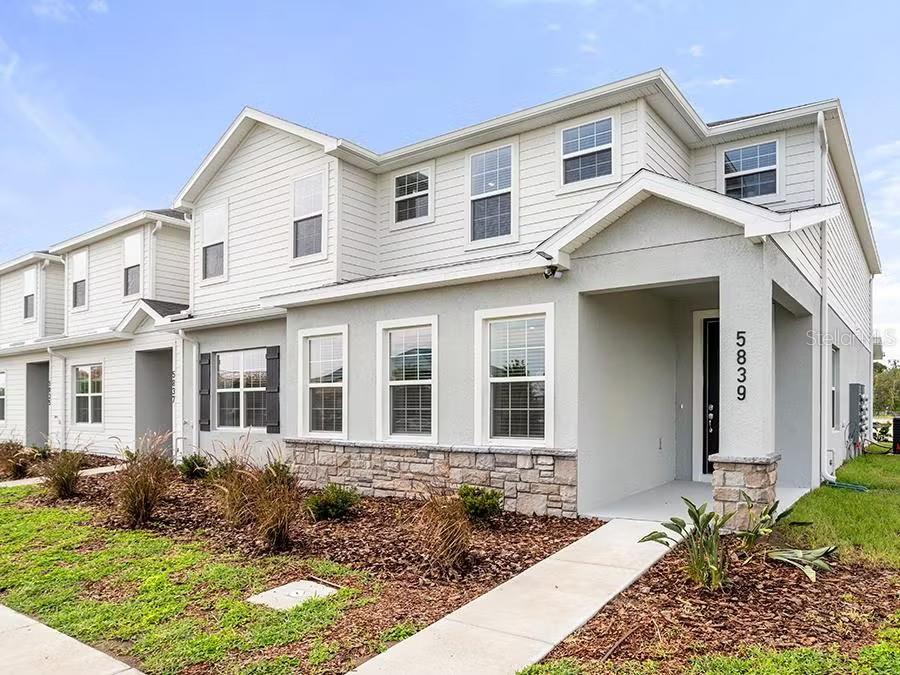 2-story new construction townhome with 1,705 square feet, 3 bedrooms with loft, 2.5 baths, a 2-car garage, located in the brand-new Crossings community offering natural and park amenities. Downstairs, a gourmet kitchen with Cambria countertops, shaker-style wood cabinets, Samsung stainless steel appliances, and a pantry. The entire lower level and upstairs baths are finished with luxury vinyl plank flooring, with stain-resistant carpet in the bedrooms. Upstairs, you'll find three spacious bedrooms including your owner's suite complete with a walk-in wardrobe, linen closet, and a private en-suite bath with dual vanities and a tiled shower. Additional features for your convenience include a half bath downstairs, loft, custom-fit window blinds throughout, a Samsung full-sized washer and dryer, energy-efficient insulation and windows, and a full builder warranty.