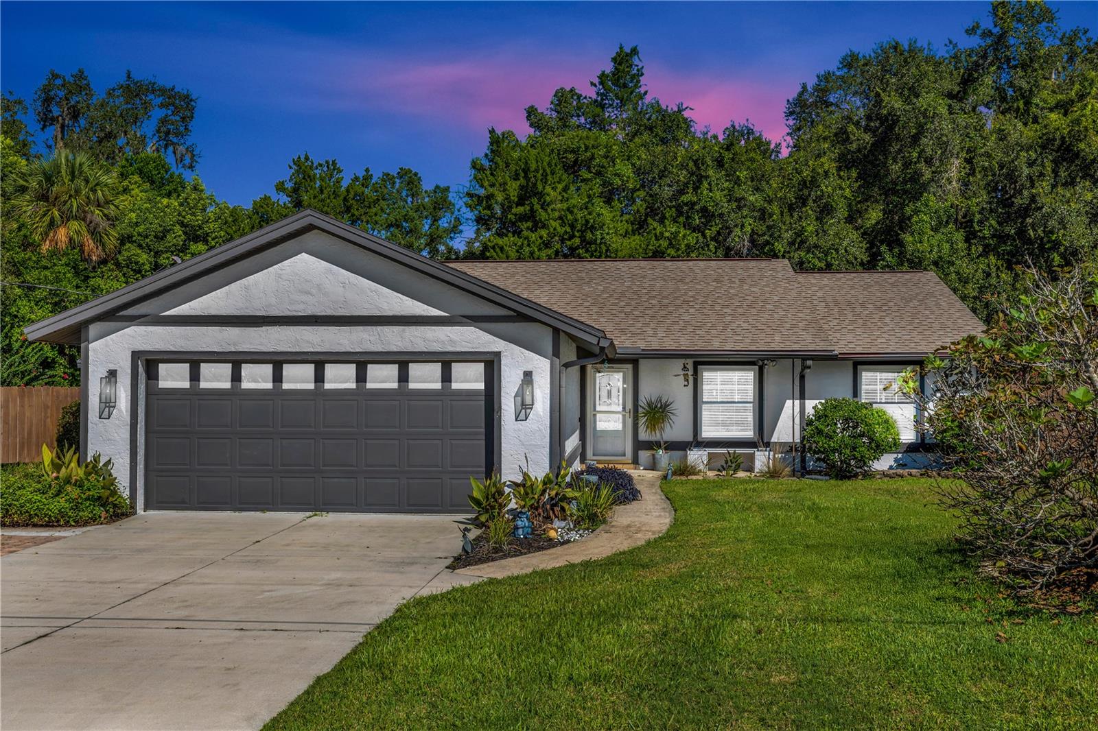 DeLand, Domingo Reyes - When it feels just right! **Seller will contribute to Buyer's closing costs** This lovely 3-bedroom, 2-bathroom ranch-style home is perfectly situated on a spacious half-acre lot, offering both privacy and room to roam. The property is fully fenced, making it an ideal sanctuary for families and pets alike. Step inside to discover a warm and inviting atmosphere that feels like home. The kitchen features stunning stone countertops and an abundance of cabinet space, perfect for all your culinary needs. Imagine gathering with loved ones in the cozy Florida room, where natural light floods in, creating a serene space for relaxation or entertainment. The three bedrooms provide ample space for family members or guests. Each room is designed with comfort in mind, ensuring restful nights and rejuvenating mornings. This home boasts durable vinyl and tile flooring throughout, combining style with easy maintenance. With a reliable well and septic system in place, you can enjoy peace of mind knowing that essential utilities are efficiently managed. Outside, you’ll find a delightful fire pit area—perfect for evening gatherings under the stars or roasting marshmallows with family. The property is equipped with a 220 plug-in for RV! No need to spend monthly storage fee to store your RV or boat. The large driveway leads to a two-car garage, providing plenty of parking space for vehicles and recreational toys. This cozy ranch is not just a house; it’s a perfect waiting to create lasting memories. Don’t miss out on this incredible opportunity!