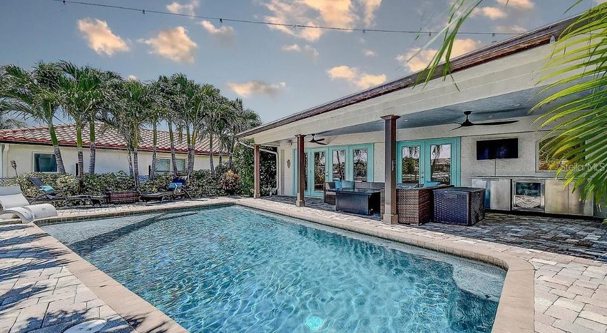 Experience the charm of a newly renovated Spanish Mediterranean-style home perfectly updated for modern living. Set along the water with a private boat dock and resort-style pool, this residence offers the ideal setting for boating, entertaining, and soaking in Florida’s year-round sunshine. Inside, elegant travertine floors flow throughout open living spaces, complemented by a refreshed kitchen with new cabinetry and fresh interior paint. A classic tile roof enhances the Mediterranean architecture while ensuring lasting durability. Enjoy peaceful mornings on the water, sunset views from your dock, and the relaxed elegance of a true Florida waterfront lifestyle.