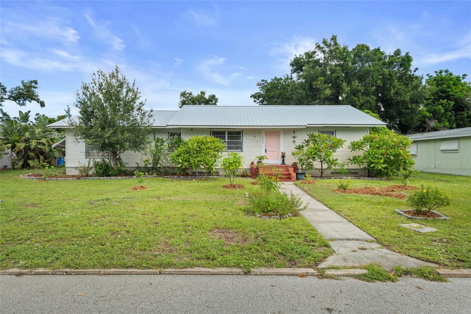 PRICED TO SELL! Welcome to historic Bradenton, where charm, location, and potential come together. This home is nestled on a quiet street in the historic Wares Creek Neighborhood just 1/2 mile west of downtown Bradenton and only 7 miles to the beach. This 3-bedroom, 1-bath home offers both character and convenience. Step inside to find beautiful original hardwood flooring throughout the main living areas, while the bonus room features classic terrazzo flooring. Already pre plumbed for a second bathroom, the bonus space is ideal for a future mother-in-law suite, income-producing rental, or expanded living area—the possibilities are endless. This home has seen key updates throughout, including a new electrical mast and panel, updated plumbing, (2021)water heater(2021), and a durable metal roof which adds lasting value and peace of mind. The bathtub has just been reglazed and new fixtures added. Master bedroom features his and her closets and a nook. Enjoy the attic fan during spring/fall to pull fresh air into the home. With no HOA restrictions and private alley access, you have the freedom and flexibility to make the space your own. With the oversized lot, (over 1/4 acre) there is potential to build a garage, studio or perhaps even add a pool and still have room to park your boat or RV. Endless opportunities to have your perfect backyard paradise surrounded by tropical fruit at your fingertips. There is an array of fruit trees including banana, mango, avocado, mulberry, soursop, and more. A full list of edible plants, trees, and bushes is available upon request. Location is key, and this home puts you close to everything—dining, shopping, schools, recreation, beaches, and entertainment. Ballard Elementary School is less than a mile away and within walking distance, adding to the appeal for families. Don’t miss this rare opportunity to own a slice of history in beautiful, historic Bradenton. **This property qualifies for a 1-Point Lender paid, full term, rate buy down if using preferred lender. Inquire for more details.**