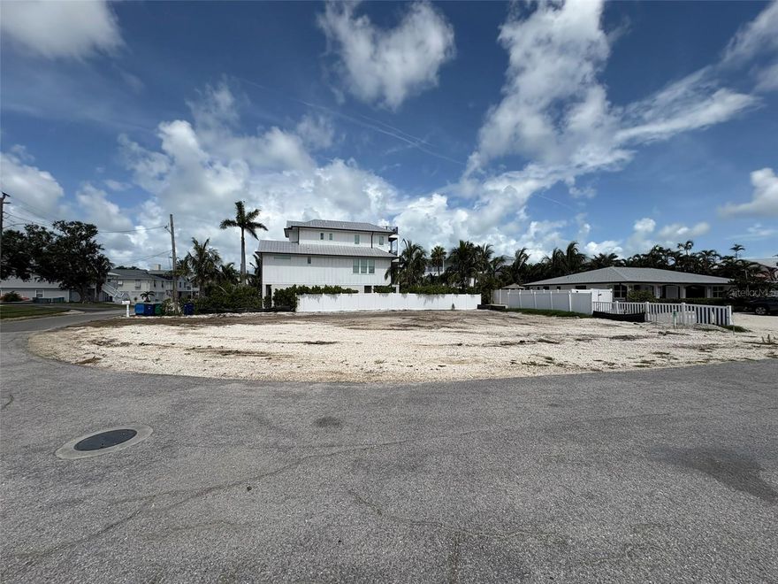 One or more photo(s) has been virtually staged. PRIME OPPORTUNITY to build a custom coastal home on this 7,500 sq ft cleared corner lot in the heart of Holmes Beach on Anna Maria Island!

Ideally located just a short 6-minute walk to the Gulf’s white sand beaches, this property offers the perfect balance of lifestyle and long-term value. With a maximum building height of 35 feet, a future home could capture beautiful water views of both the Gulf of Mexico and the Intracoastal Waterway, creating a true elevated island living experience.

Positioned near local dining, shops, access to a community boat ramp for effortless days on the water. The location supports both everyday enjoyment and strong visitor appeal. Zoned for weekly rentals, the property provides flexibility for personal use, seasonal enjoyment, and income generation. Opportunities with this level of flexibility on Anna Maria Island are very limited.

Any renderings or home concepts shown are for illustrative purposes only and are not included in the sale. Buyers should conduct their own due diligence regarding design, permitting, and construction.

For investors: The combination of weekly rental zoning, walkable beach access, and potential water views creates a compelling opportunity to develop a high-demand vacation rental in a supply-constrained market.

For second-home buyers: Design a private coastal retreat tailored to your lifestyle, with the added benefit of generating income when not in use—allowing your beach home to work for you while you’re away.