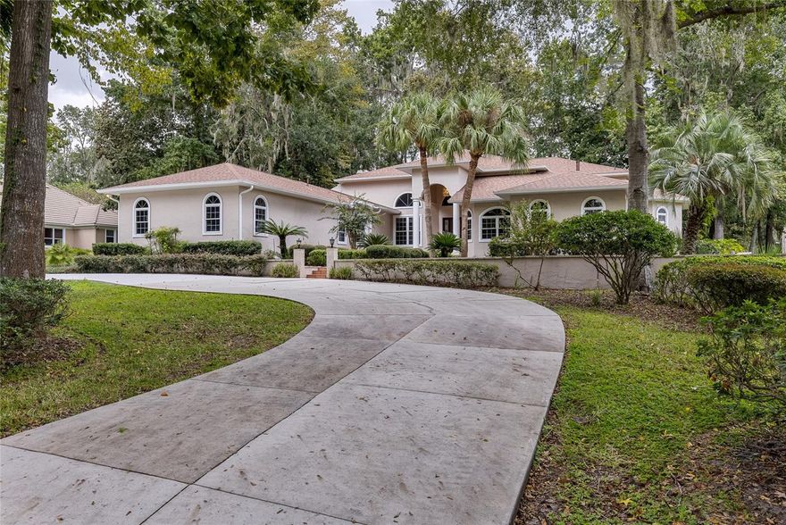 If Golf is your activity, then look no further than the this fully remodeled luxury residence nestled on a one-acre lot in the prestigious guard-gated Country Club of Ocala. Overlooking the pristine golf course, this five-bedroom pool home blends timeless elegance with modern upgrades, offering the ultimate retreat for refined living. Inside, you are greeted by soaring eighteen-foot ceilings and an abundance of natural light streaming through grand arched windows. The open-concept kitchen is a chef’s dream, featuring stainless steel appliances, a gas range with hood, soft-close custom cabinetry, ample storage, a large center island, and a charming dining area overlooking the pool. Just off the kitchen is a spacious butler’s pantry and laundry room complete with extra cabinetry, closet storage, a utility sink, and a washer and dryer that convey with the home. The kitchen flows seamlessly into the grand living area, where a striking floor-to-ceiling tiled gas fireplace creates an impressive focal point for the space. The primary suite is a true sanctuary, offering high ceilings, crown molding, a private fireplace, and direct access to the pool. The master bath is an extraordinary retreat, boasting over 380 square feet of upgrades including floor-to-ceiling tile, a soaking tub, dual vanities, a dual-headed walk-in shower, and a fireplace that elevates the spa-like atmosphere. A spacious walk-in closet with custom built-ins completes the owner’s wing. Each of the additional bedrooms and bathrooms has been fully remodeled with designer finishes, providing comfort and sophistication throughout. Outdoors, the screened-in pool and spa create a private paradise with generous space for entertaining while overlooking sweeping views of the golf course. With a new roof installed in 2023, this home offers both peace of mind and modern luxury in one of Ocala’s most sought-after neighborhoods. From elegant interior finishes to its resort-style outdoor living, this property represents the best of Country Club living and is a rare opportunity for those seeking a refined lifestyle on the course.