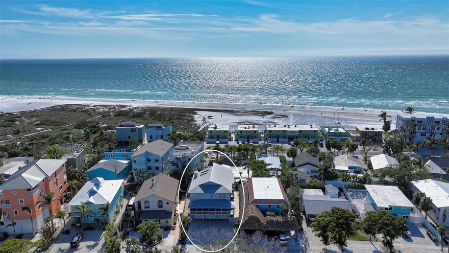 Just steps from vibrant Siesta Key Village and the world-famous Siesta Key Beach, this rustic coastal getaway offers an exceptional location with endless potential. Zoned RMF1, the property currently features two fully furnished, income-producing apartments ideal for daily, weekly, monthly, or annual rentals. Apartment 126, located on the second level, includes two spacious bedrooms, two bathrooms, a cozy eat-in kitchen, and a comfortable living room. A private balcony, accessible from both bedrooms, provides a peaceful outdoor space to enjoy refreshing coastal breezes. On the third level, Apartment 128 offers three light-filled bedrooms and an inviting living and dining area with views of the Gulf of Mexico. Vaulted wood-paneled ceilings add warmth and character, while the large private terrace creates the perfect setting for relaxing, entertaining, or simply soaking in the stunning surroundings. The property also includes a three-bay garage that accommodates six tandem-parked vehicles, an invaluable convenience in this prime location. On the ground level, a spacious patio and outdoor shower provide the ideal setup for rinsing off after a day at the beach. Whether you plan to continue using it as a successful rental property, remodel the existing structure, or build your dream coastal home, this unique offering presents a rare opportunity to own a piece of paradise in one of Florida’s most desirable coastal destinations.