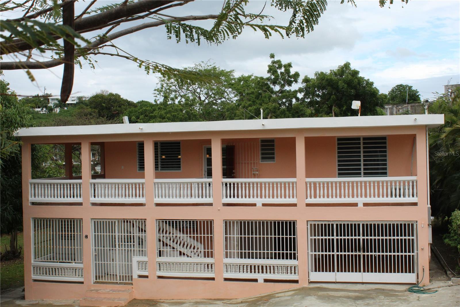 Casa Margarita is a duplex home located in the beach-side neighborhood of Bravos de Boston with dreamy ocean views from the second floor apartment. The home is ideally suited for an owner to live in one apartment while using the other for rental income or any combination that may fit you.
Located a short stroll from the ferry docks and the town of Isabel Segunda you have easy access to banks, grocery stores, restaurants/bars and shops. The Casa has a wonderful park like setting that is fully fenced with mature trees including Avocado, Mango and Star fruit.
The house house has two stories with an apartment on each floor. The first floor currently has a long term month to month tenant and has two bedrooms, one newly rented bathroom, full kitchen with living area and an open air covered outdoors space.
The upstairs apartment is very open with wrap around covered balconies, cooling breezes and ocean views to the North. The apartment has high ceilings, a large open entertaining kitchen and great room. There are two bedrooms and two bathrooms with the primary bedroom having an en suite with a large walk in closet.
From the second floor apartment there is a stairway to the roof top with expansive ocean views. Further development of the roof could become a wonderful entertaining space.
The four bedrooms have newer mini-split air conditioning units and both kitchens are fully equipped.