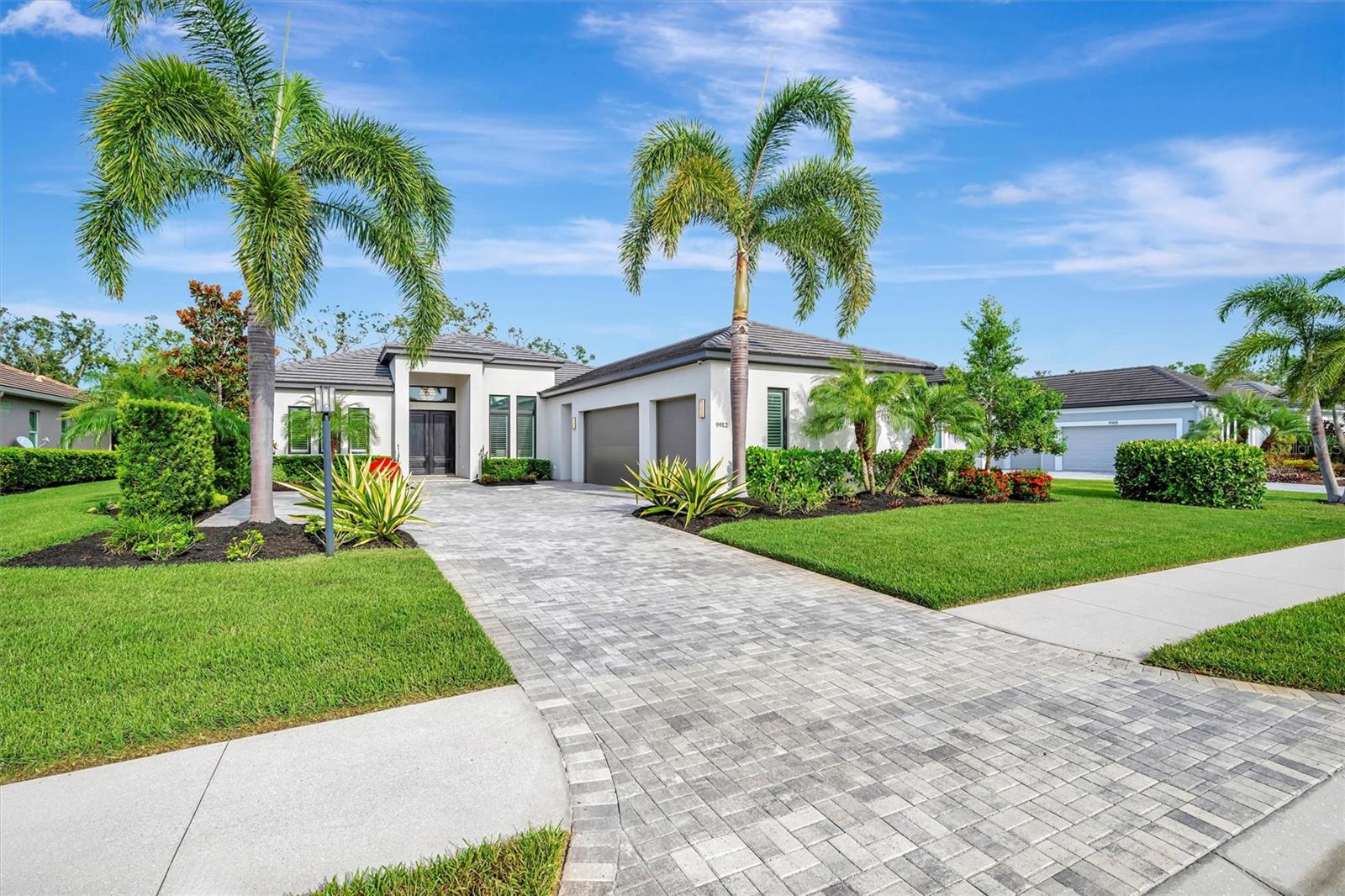 One or more photo(s) has been virtually staged. Video Tour- https://iframe.videodelivery.net/2c30542a628e710aadd3edc65f8205a7 Welcome to this stunning John Cannon luxury custom-built home, where timeless craftsmanship meets sleek European modern design. As you arrive, you’ll be drawn in by the impressive curb appeal—an oversized brick paver driveway, lush tropical landscaping with foxtail palms, landscape lighting, and a modern 3-car garage with contemporary fixtures and a tile roof. The Solid Mahogany double entry doors open into a 14-foot grand foyer, anchored by a designer chandelier that sets a warm and sophisticated tone. Inside, you'll be captivated by 12-foot ceilings with crown molding throughout the main living areas and primary suite.Straight ahead, the view is framed by dramatic 10-foot pocket sliding glass doors—a true architectural statement—that instantly draw you toward the space where indoor transitions to outdoor. The pocket sliders disappear into the walls, connecting you to a panoramic view, screened-in lanai with a heated, saltwater pool, outdoor kitchen, fully fenced yard, and serene preserve views—your own private retreat for enjoying the peaceful Florida setting. A whole-home speaker system carries your favorite music throughout, inside and out. Head back inside to the open floorplan, ideal for everyday comfort and upscale entertaining. The living/dining area features a striking custom gas fireplace that creates a cozy yet sophisticated focal point, while designer lighting enhances the ambiance. Enter the gourmet kitchen, a chef’s dream, outfitted with Cambria quartz countertops, contemporary solid wood cabinetry, abundant storage including drawers and under-island cabinets, and top-of-the-line appliances including Wolf, Miele, and Asko. A Wolf Sub-Zero refrigerator and a built-in, plumbed Miele coffee system elevate the experience for daily living and entertaining alike.
The primary suite is a luxurious retreat with soaring ceilings, dual walk-in closets, and an en-suite spa bathroom with frameless glass shower, spa-style jets, dual sinks, quartz counters, and built-in storage. The split floorplan provides privacy for all. The office near the front of the home offers a bright space for work. The second bedroom is located near the rear of the home, just off the game room and shares a full bathroom with the main hallway. The game room is perfect for entertaining, with pocket sliders that open up to the lanai, continuing the home's seamless indoor-outdoor living concept.The third Bedroom is tucked off the kitchen, and features its own private bath, ideal for guests. Also in this wing: a large laundry room with counter space and cabinetry, and access to the oversized 3-car garage. Additional upgrades throughout include: Hunter Douglas plantation shutters and shades including motorized UV shades over all sliders, wood-look tile flooring, crown molding, CAT 5 impact-rated windows and doors, and ISO foam insulation for maximum energy efficiency. This home is nestled in The Links, an exclusive section of Rosedale Golf & Country Club which combines elegance, function, and resort-style living with no CDD fees. Located under 2 miles from parks, trails, and sports complexes, and just minutes to shopping, restaurants, medical facilities, and the pristine Gulf Coast beaches. Rosedale offers guard gated security and a vibrant social lifestyle with an 18-hole championship golf course, Har-Tru tennis courts, Olympic-size pool, fitness center, clubhouse with dining and events.