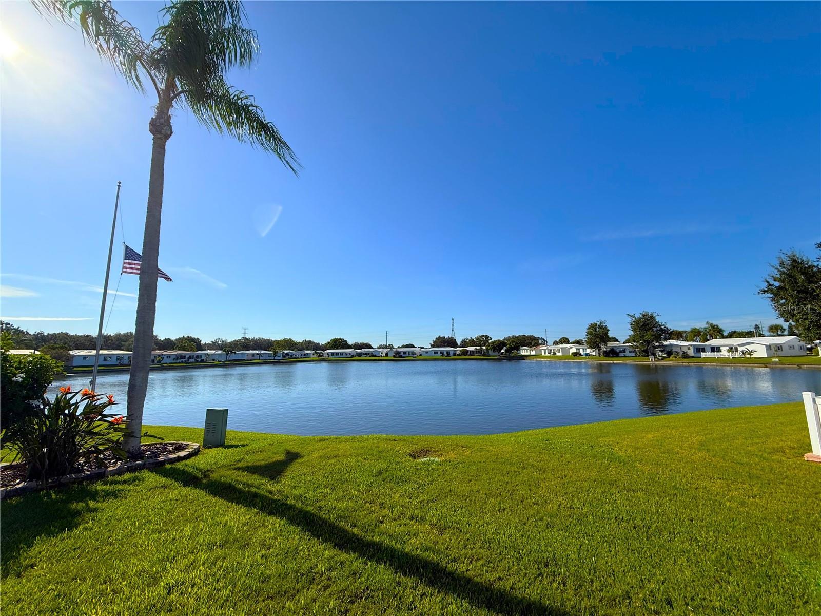 Location, Location, Location! This stunning move in ready waterfront corner lot has it all! The kitchen has been thoughtfully updated, featuring Plenty of storage space, elegant Quartz countertops, sleek stainless-steel appliances, under-cabinet lighting, a custom tiled backsplash, recessed lighting, and a reverse osmosis water filtration system, all while offering picturesque views of the lake! High-impact windows throughout the home are adorned with custom plantation shutters, enhancing both aesthetics and functionality. The interior boasts some newer paint, adding a fresh touch. The versatile third bedroom can serve multiple purposes, functioning as a home office, gym, or craft room, depending on your needs. Outside, the spacious covered lanai is surrounded by lush tropical landscaping, creating a serene atmosphere. A charming brick-paved walkway leads to the rear of the property, where an oversized brick-paved patio awaits, perfect for enjoying breathtaking Florida sunsets, enhanced by mature landscaping that provides privacy and expansive water views. Nestled in a vibrant, amenity-rich community, you'll enjoy easy access to Mainlands Sparkling Community Heated Pool and Clubhouse, Mainlands Golf Course, Freedom Lake Park that offers: Dog Park with large, fenced exercise space separated for large and small dogs, hydrants, watering holes, and plenty of shade for your pets, covered outside fitness stations, fishing, grilling, picnic tables, pavilions, new playground, walking track and the Korean War Memorial. This home's ideal location puts you close to all the best that the area has to offer - from world-class Gulf Beaches, Sam’s Club, Coffee Shops, Fitness Centers, shopping, dining, Helen Howarth Park, Equestrian Trail, Dog Park, and Forbes recreation area, I-275, St. Pete/Clearwater and Tampa International Airports. Whether you're an adventure-seeker or simply seeking a peaceful oasis, this home offers the perfect setting to elevate your Florida lifestyle.