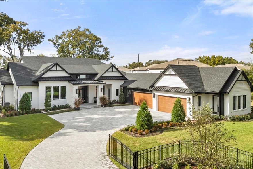 One or more photo(s) has been virtually staged. Welcome to 1206 Sutter Avenue, a truly exceptional estate and the crown jewel of Gotha, Florida—where refined luxury meets modern innovation. This 2025 build offers 5,772 square feet of thoughtfully designed living space, set on an expansive, nearly one-acre lot that provides privacy, presence, and sophistication.
Recent enhancements elevate the property even further and include a putting green, two new AC units servicing the garage bays, a whole-home generator, electric sun shades, custom window treatments, a pool safety fence, a new AV system, and a newly added shed (2025)—ensuring comfort, functionality, and peace of mind.
Step through grand 8-foot iron entry doors into a striking foyer adorned with elegant checkered marble flooring. The living room impresses with soaring vaulted ceilings, custom wood beams, and a Montigo DelRay 46” gas fireplace, creating a warm yet dramatic setting ideal for both intimate gatherings and grand entertaining.
The gourmet kitchen is a true showpiece, designed for the most discerning chef. It features rift white oak cabinetry with inset soft-close doors and drawers, double-thick nosing marble-style quartz countertops, two full-size sinks with Brizio faucets, and a 48” Thermador Pro Grade gas range with a wall-mounted Brizio pot filler. Additional highlights include two Thermador stainless steel dishwashers, a Thermador 30” double oven, and an oversized 66” professional side-by-side refrigerator and freezer. A spacious, custom walk-in pantry completes this exceptional culinary space.
The primary suite is a private retreat, offering a spa-inspired ensuite bath with Carrara marble mosaic flooring, a curbless shower with body jets, and beautifully crafted custom vanities. Upstairs, a private guest suite with its own ensuite bath provides comfort and privacy for visitors.
A custom home office with built-in bookshelves offers a refined workspace, while the game room is designed for entertainment, featuring built-in speakers, a bar with a Samsung smart refrigerator, and expansive patio sliders that open seamlessly to the outdoor living area.
Outside, enjoy a true entertainer’s paradise with a resort-style pool and spa, fully equipped outdoor kitchen, and lush surroundings. The oversized four-car garage, fully fenced yard, and mature oak trees enhance the home’s private, estate-like setting.
Equipped with state-of-the-art amenities and meticulously curated finishes throughout, 1206 Sutter Avenue offers a lifestyle of unparalleled elegance, comfort, and distinction.
Schedule your private tour today and experience Gotha luxury at its finest.