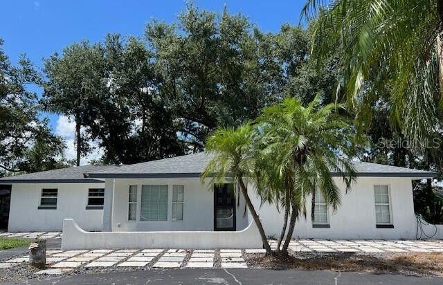 Welcome to this lovely home, on a shaded one-acre lot, in Walk in Water Lake Estates, Lake Wales. This home showcases an updated kitchen with granite countertops, stainless steel appliances, a spacious pantry, and view that opens into the family room, with sliders to the back open porch. Formal living room at front of home with a bay window, The spacious primary suite includes a walk-in closet, and remodeled floor-to-ceiling tiled shower with dual shower heads. Second bedroom with walk-in closet and tiled shower. Additional features include circular driveway, chain linked fence yard, enclosed garage with laundry area, and additional covered parking.
