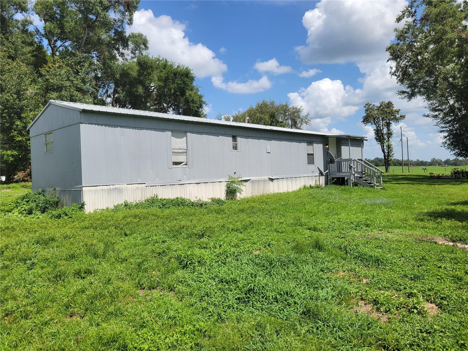 This property is a recently renovated mobile home sitting on a 3 acre lot with 2 bedrooms and 2 bathrooms. The unit has a laundry room with washer and dryer. The water is from a well on the property so no need to worry about a utility bill for water/sewer. It sits on a very spacious, quiet lot across the street from farmland. Call to schedule a showing today.