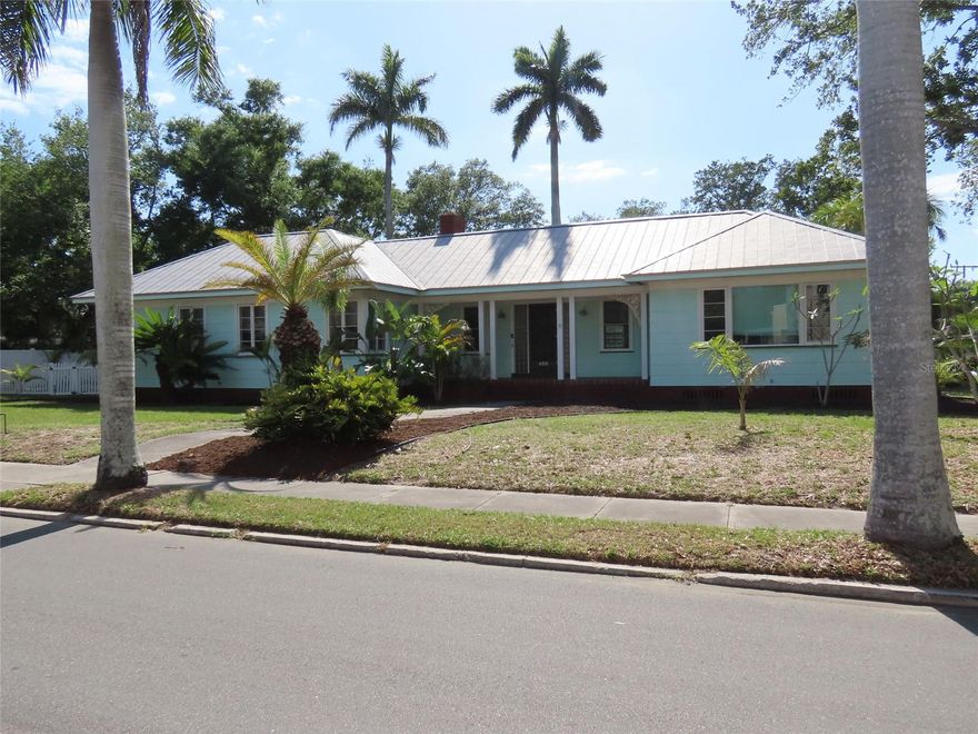 Step into the timeless character and charm of this vintage residence situated on an expansive 0.40-acre corner lot in Bradenton. Offering over 2,400 square feet of living space, this 3-bedroom, 3-bath home presents a unique opportunity to appreciate original architectural details while adding your own personal touches over time. From the moment you arrive, the tranquil front porch invites you to slow down and unwind—an ideal setting for morning coffee or a relaxing afternoon.
Inside, the home features a traditional layout with a formal living room centered around a fireplace and a separate formal dining room, creating inviting spaces for everyday living and gatherings. A spacious Florida room filled with windows allows natural light to pour in, creating a bright and inviting space perfect for relaxing, reading, or additional living area. The kitchen is equipped with a gas range, and central air conditioning adds to the home’s functionality. Wood flooring runs throughout much of the home and, with a bit of attention, offers the potential to truly shine and enhance the home’s warmth and character. Original details throughout contribute to the home’s distinctive vintage appeal.
The primary suite includes an ensuite bath with both a tub and separate shower, while the additional bedrooms provide flexibility for a variety of needs. A thoughtfully designed transition space off the garage includes a laundry room and full bath, offering a practical buffer before entering the main living area—ideal for everyday convenience. The oversized two-car garage also features a dedicated workbench area, perfect for hobbies, projects, or additional storage.
Outdoors, the generous yard is filled with mature trees and lush foliage, creating a private, natural setting with endless possibilities—whether you envision expanding outdoor living areas, gardening, or simply enjoying the space as it is. The durable metal roof adds long-term value and peace of mind.
Conveniently located approximately 2 miles from Downtown Bradenton and the Riverwalk, about 10 miles to the beaches of Anna Maria Island, and roughly 12 miles to Sarasota, this property offers access to a wide range of dining, shopping, arts, and recreational opportunities. Nearby parks, golf courses, and waterfront areas further enhance the appeal of the location.
This property offers a rare combination of space, character, and potential in a well-established area of Bradenton. All information is believed to be accurate but is not guaranteed. Buyers and agents to verify all facts and information pertinent to their purchase decision.