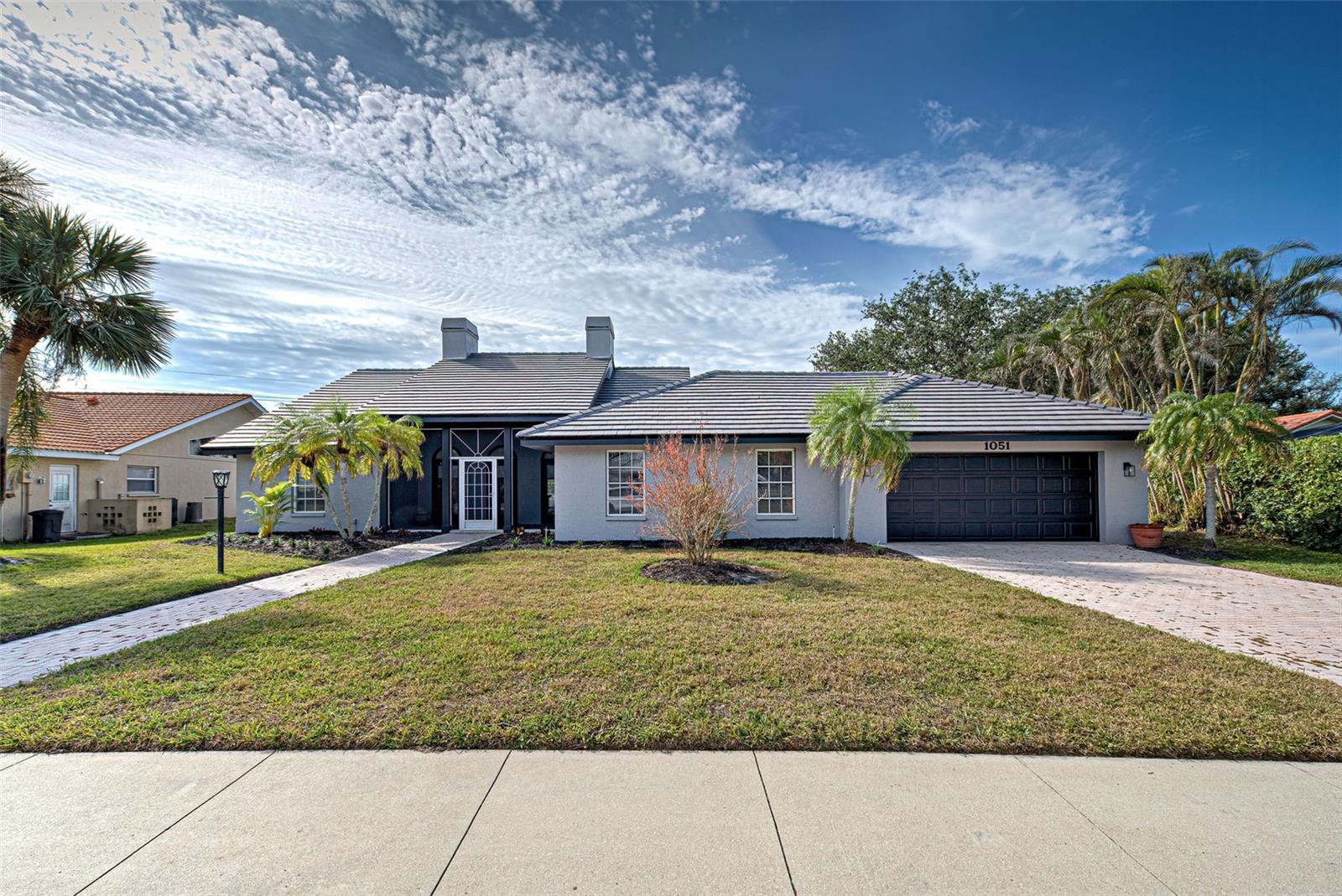 BUY THIS REMARKABLE HOME FOR AS LOW AS 4.875% INTEREST RATE (based on current rates). SELLER IS OFFERING A 2-1 BUY DOWN!! DON'T MISS THIS AMAZING OPPORTUNITY! Situated on an oversized lot with a private lake view. A truly unique floor plan offers plentiful options for customizing your lifestyle. Paver brick drive and walkway lead to a charming screened front porch with a French door entry. Enter to the spacious great room featuring a wood burning fireplace, built-ins, dramatic mirrored wall and unobstructed views of the pool and lake beyond. The kitchen and dining area are open to the great room, perfect for entertaining. The primary suite is massive with French doors leading to the pool area. The ensuite bath boasts dual vanities, garden tub, shower, make-up vanity and large his and hers walk-in closets. The split floor plan provides guests with ample privacy in oversized guest rooms that share a bath. There are two bonus rooms in this spacious 2703 square foot home. The first features hard wood floors and can be utilized for a home office, gym, studio or play room. Step down to the second bonus area currently used as a craft room. The possibilities are endless! Oversized two car garage with attic storage can handle all your vehicles and toys. The pool area features an outdoor kitchen with sink, full bath and beautiful water views. All the big-ticket items are done for you. New roof in 2024; AC in 2023 with UV filter and storm kit added in 2024; Hot water heater 2023. Exterior painted including all trim in 2024. With a few cosmetic updates this could be your dream home! Located in Laurel Woodlands, this community offers unique homes on large lots. Perfectly situated within minutes to the new hospital, I-75, Publix, pristine beaches and downtown Venice with its charming ambiance, quaint shops, and superb dining options.
