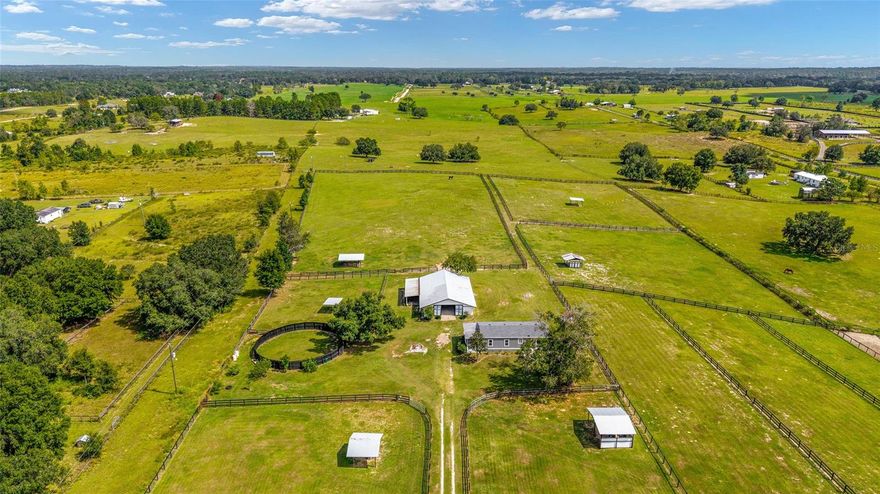 Discover peaceful country living on this 9+ acre Dunnellon property featuring a cozy 2-bed, 2-bath home, a 7-stall concrete block barn, and multiple fenced pastures. Zoned A-1, it’s perfect for horses, livestock, or hobby farming.

Enjoy wide-open spaces and simple country comfort. The home offers an updated master room and bath, new roof (2025), updated windows (2024), and a large screened porch overlooking the green pastures. The center-aisle barn includes seven stalls (three 12x12 and four 12x15), a feed room, wash rack with hot & cold water, hay storage, and an A/C tack room.

Several fenced paddocks, plus two RV carport hook-ups (30 amp & 50 amp) add convenience. The property is gated, fully fenced, and features a private well and septic. Located on a quiet paved road, this well-maintained farm offers a peaceful rural setting just minutes from shopping, dining, and outdoor recreation at Rainbow Springs—and only 11 minutes to WEC.