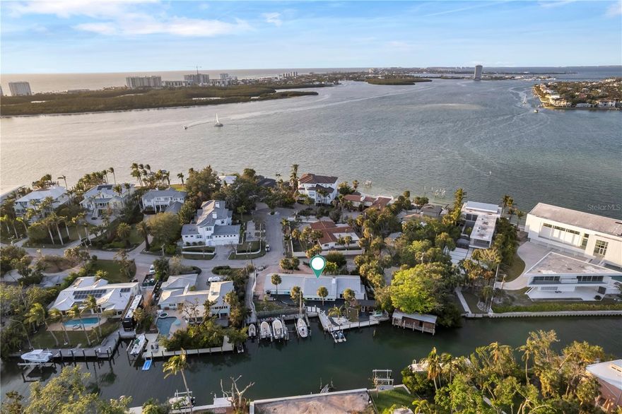 Turnkey Waterfront Retreat on Siesta Key – A Fully Furnished Coastal Paradise! Discover the ultimate coastal lifestyle in this fully furnished, move-in-ready 4-bedroom, 3-bathroom waterfront retreat on the north end of Siesta Key. Perfectly situated just minutes from Sarasota’s top attractions, this home blends luxury, tranquility, and convenience. Set on 0.4 acres of deep sailboat water, the property boasts 68 feet of waterfrontage on Bayou Louise and a 20-foot dock with direct, bridge-free access to Big Pass and the Gulf of Mexico. Spend your days boating, fishing, or enjoying sunsets over the Gulf. A quick 5-minute boat or kayak ride leads to a vibrant sandbar, ideal for fun and relaxation. Surrounded by neighboring homes valued at $20+ million, this property offers a rare opportunity for luxurious waterfront living. Tropical landscaping creates a serene oasis with a spacious deck, an outdoor grill, and a gazebo for entertaining or unwinding after a day on the water. Inside, the home exudes modern coastal charm. The gourmet kitchen features quartz countertops, stainless steel appliances, and designer touches, while the family room offers stunning water views through impact sliding doors. The primary suite is a private retreat with its own entrance, a custom walk-in closet, and spa-like finishes. An additional in-law suite with a private entrance provides added flexibility and convenience. This exceptional property is just a 5-minute walk to Shell Road Beach, 3 miles from Siesta Key Village, and 3.3 miles from the world-renowned Siesta Key Beach. The sandbar is a short 5-minute kayak ride, while downtown Sarasota and St. Armands Circle are just a quick drive away. Fully equipped with linens, beach towels, bicycles, cookware, a coffee maker, LED lighting, and more, this home ensures a seamless and comfortable stay. Available for both short- and long-term rentals, it’s perfect as a luxurious personal retreat, an entertainer’s dream.