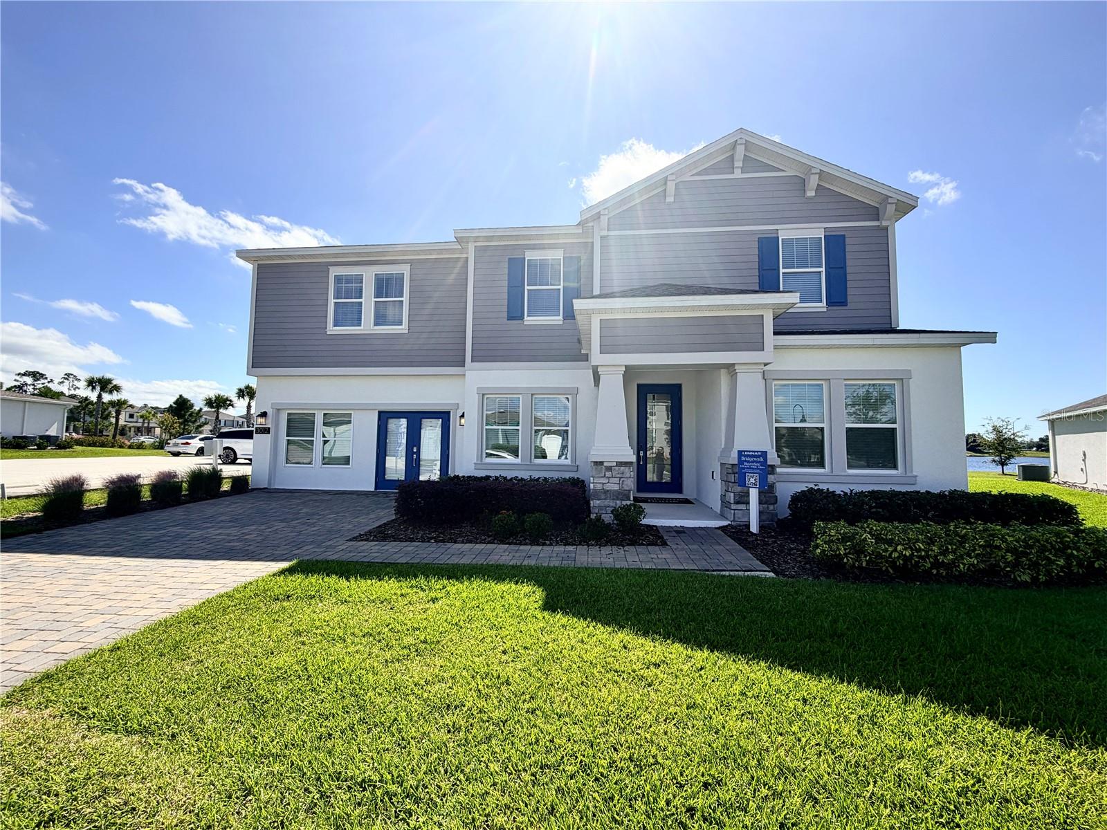 Why Wait to Build? Discover this stunning, never-lived-in former model home located in the tranquil Bridgewalk community. Set on a spacious lot with picturesque pond views, this impressive residence offers the perfect canvas to create your own outdoor oasis. A 7.125 kW solar system helps significantly reduce monthly energy costs.
Step through the glass-paneled front door into a bright, open foyer that leads to a formal dining room—ideal for hosting gatherings and special occasions. The large family room showcases beautiful water views and flows seamlessly into the breakfast nook and gourmet kitchen, making it perfect for entertaining. The chef-inspired kitchen features 42” upper cabinets, stainless steel appliances, a glass tile backsplash, a large quartz island, and pond views that make every meal prep a pleasure. A main-floor bedroom and full bath offer an ideal setup for overnight guests or multigenerational living.
Upstairs, a generous game room provides the perfect space for family fun or relaxation. The expansive owner’s suite features tray ceilings, serene pond views, dual walk-in closets, and a luxurious spa-style bath with a soaking tub, dual vanities, a makeup station, private water closet, and a spacious walk-in shower. Three additional bedrooms—each with walk-in closets—a guest bath, and a conveniently located laundry room complete the second level.
Additional highlights include a three-car tandem garage, a large covered patio with water views, and a spacious backyard perfect for customizing your dream outdoor retreat or creating a secure space for pets.
Bridgewalk offers an exceptional lifestyle with resort-style amenities, including a clubhouse, fitness center, lap and leisure pools, BBQ area with built-in grills, picnic pavilion, dog park, playground, pickleball and volleyball courts, and a private boat launch. Lawn maintenance is included, allowing for easy, low-maintenance living.
Zoned for Voyager K–8 and Tohopekaliga High School, residents enjoy access to some of the area’s top-rated schools. Ideally located just minutes from Lake Nona, Medical City, SR 417, and the Florida Turnpike, Bridgewalk combines a peaceful neighborhood atmosphere with convenient access to premier shopping, dining, and entertainment.
Don’t miss your chance to own a nearly new, feature-rich home in one of St. Cloud’s most sought-after communities—schedule your private showing today! **Garage conversion to be complete by end of November**
