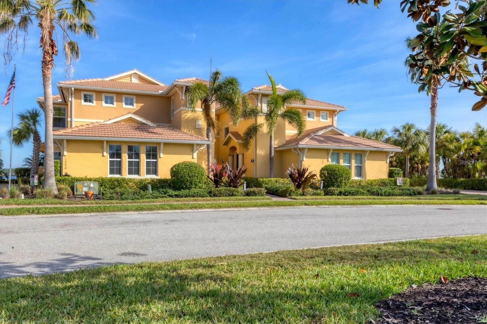 This stunning end unit Carriage home boasts stunning views of the Manatee River from almost every window. You can enjoy the convenience of the community pool situated immediately adjacent to the property for your relaxation and leisure. With 2,332 SF of Living Space this open floor plan offers a great Room, gourmet kitchen, dining room, 3 bedrooms, 2 bathrooms, with Den/office. The interior design incorporates customized features to include brick panel and shiplap accent walls, beautiful lighting, plantation shutters, crown molding, hardwood flooring throughout the main living and in the primary bedroom. This home also includes impact glass windows, new AC November 2024, Laundry Room with built in cabinets, attached 2 Car Garage, and a private Elevator. A large screened porch with expansive river views provides an ideal sanctuary for unwinding and enjoying the surroundings. The brick tile flooring on the patio adds both aesthetic appeal and durability, making it easy to maintain. This ideal location is in walking distance to all the community offers: Boating Lifestyle with the Private Marina, Heated Community Pool, Fitness Center, Tennis Courts, Nature Trails, Playground, and Dog Park.