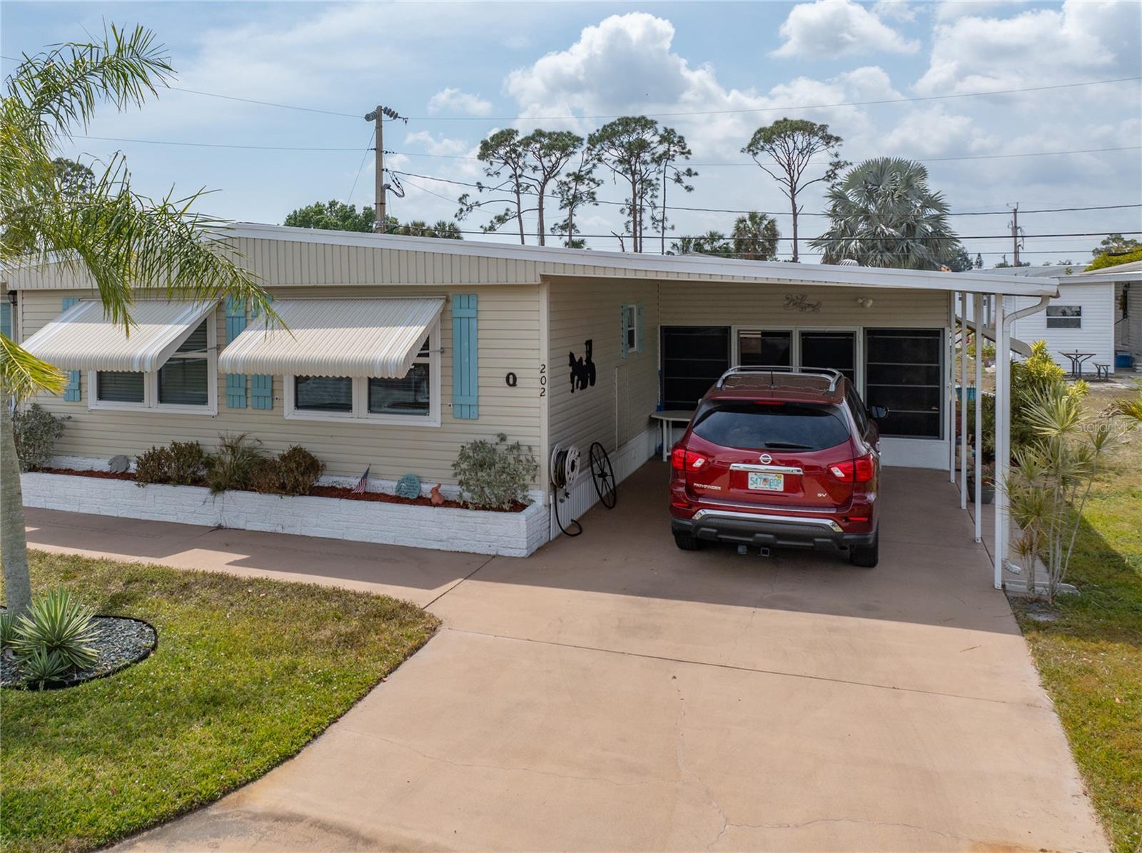 Welcome home! This well-cared-for 2-bedroom, 2-bath manufactured home is filled with charm, comfort, and the perfect mix of space and functionality. Tucked into a wonderful, active community, this property also features a versatile bonus room—ideal as a craft space, office, or guest room. Step inside and you’ll immediately feel the warmth. The open living and dining areas are bright and inviting, with plenty of natural light and room to relax or entertain. The kitchen offers ample cabinetry and counter space, making meal prep a breeze. The spacious primary suite features a walk-in closet and private bath, while the second bedroom and bath are perfect for guests or family. The bonus room gives you flexibility for whatever suits your lifestyle. Outside, enjoy your morning coffee on the three season lanai or unwind in the fresh air. The home sits on a low-maintenance lot, giving you more time to enjoy everything the community has available. Community amenities include: Billiards, Boat Storage, Bocce Court, Clubhouse, Sparkling Community Pool, Community Room & Hobby Room, Library, Putting Green and Shuffleboard. Whether you’re looking for a seasonal escape or a year-round retreat, this home has everything you need—and more—in a location that’s close to shopping, dining, and medical services. This gem won’t last long—schedule your private showing today!